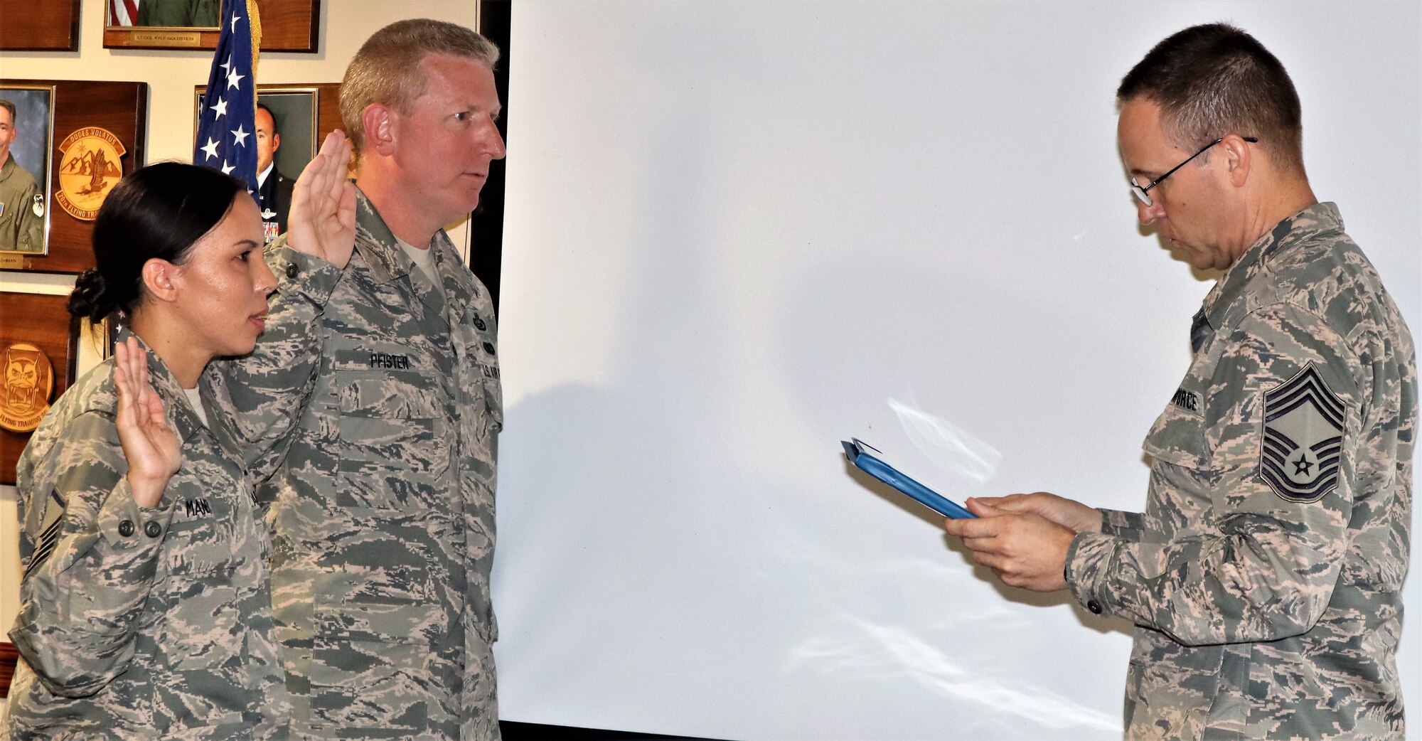 340th Flying Training Group superintendent Chief Master Sgt. Scott Goetze administers the SNCO oath to new SNCO corps inductees, Master Sgt. Angelina Manby and Senior Master Sgt. Craig Pfister following ceremonies at JBSA-Randolph, Texas on Nov. 1.