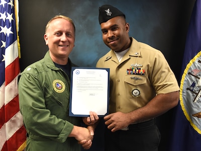 Vincent Barnes (right), assigned to Navy Recruiting Station New Braunfels, was meritoriously advanced to the rank of petty officer first class during a promotion ceremony held at Navy Recruiting District San Antonio Headquarters by Cmdr. Jeffrey Reynolds.