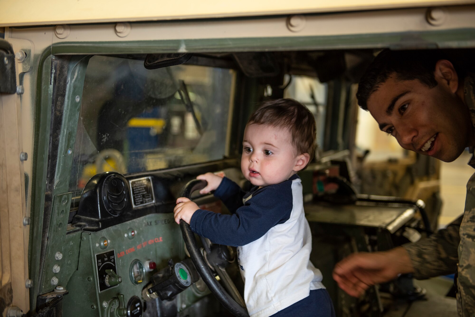 U.S. Air Force Capt. Joshua DeFrank, 377th Logistics Readiness Squadron deputy commander, plays with his son, James, in a Humvee during a spouse immersion event for the LRS vehicle management flight at Kirtland Air Force Base, N.M., Oct. 30. Key spouses participated in the spouse immersion event to familiarize themselves with the vehicle management flight and provide them with an overview of their mission and resources that support Team Kirtland. Spouses and children were able to explore the different vehicles that the flight manages and maintains. (U.S. Air Force photo by Airman 1st Class Austin J. Prisbrey)