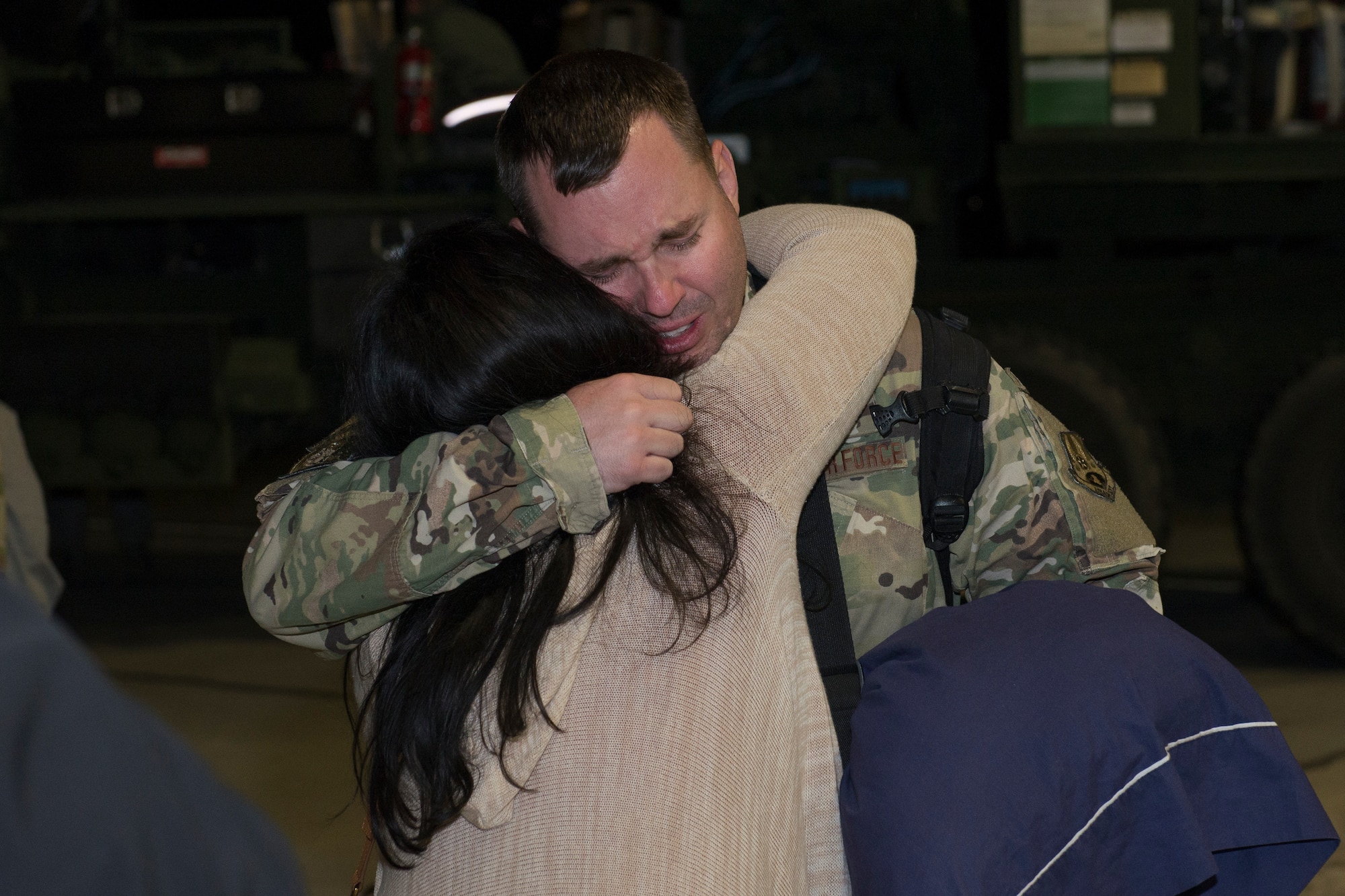 An Airman from the 726th Air Control Squadron returns from deployment and embraces his spouse, October 27, 2018, at Mountain Home Air Force Base, Idaho. over 100 Airmen from the 726th ACS deployed with mission of supporting communication between air craft and ground units. (U.S. Air Force photo by Senior Airman Tyrell Hall)