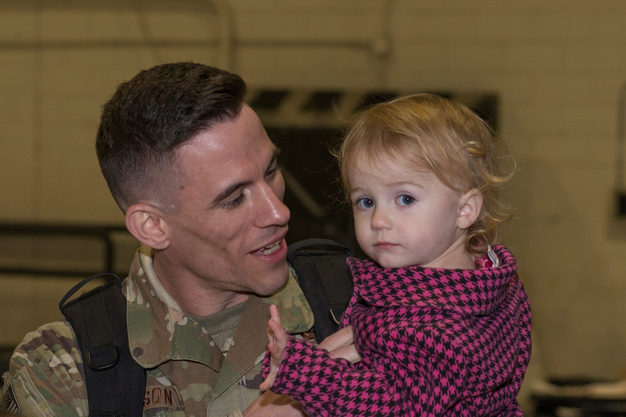 An Airman from the 726th Air Control Squadron returns from deployment and holds his child, October 27, 2018, at Mountain Home Air Force Base, Idaho. 120 Airmen from the 726th ACS deployed with mission of supporting communication between air craft and ground units. (U.S. Air Force photo by Senior Airman Tyrell Hall)