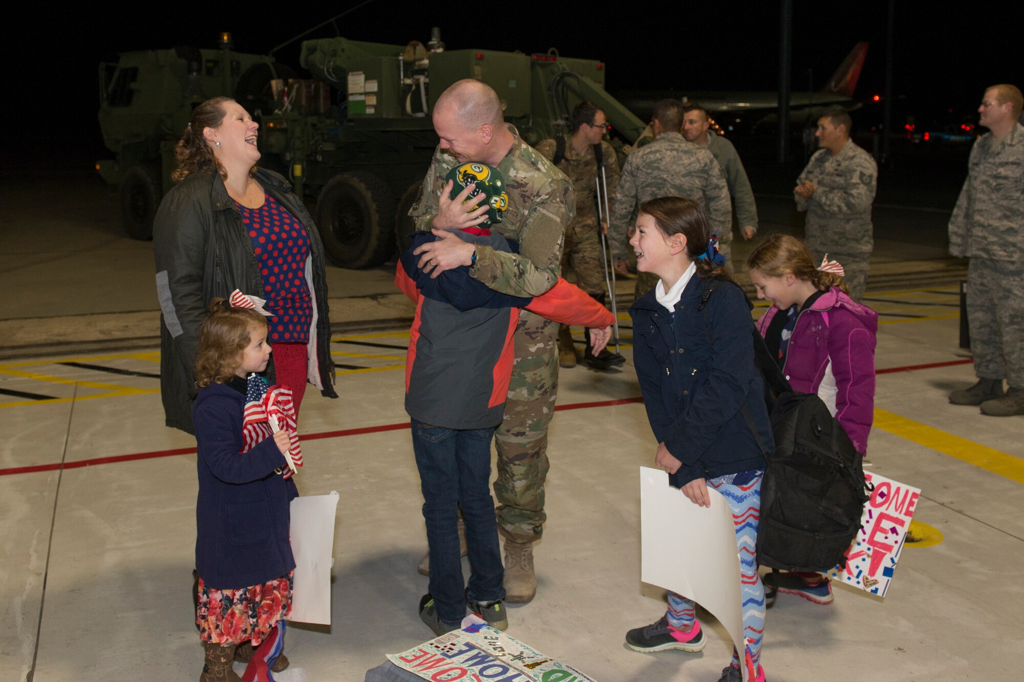 An Airman from the 726th Air Control Squadron returns from deployment and embraces his family, October 27, 2018, at Mountain Home Air Force Base, Idaho. Over 100 Airmen from the 726th ACS deployed with mission of supporting communication between air craft and ground units. (U.S. Air Force photo by Senior Airman Tyrell Hall)