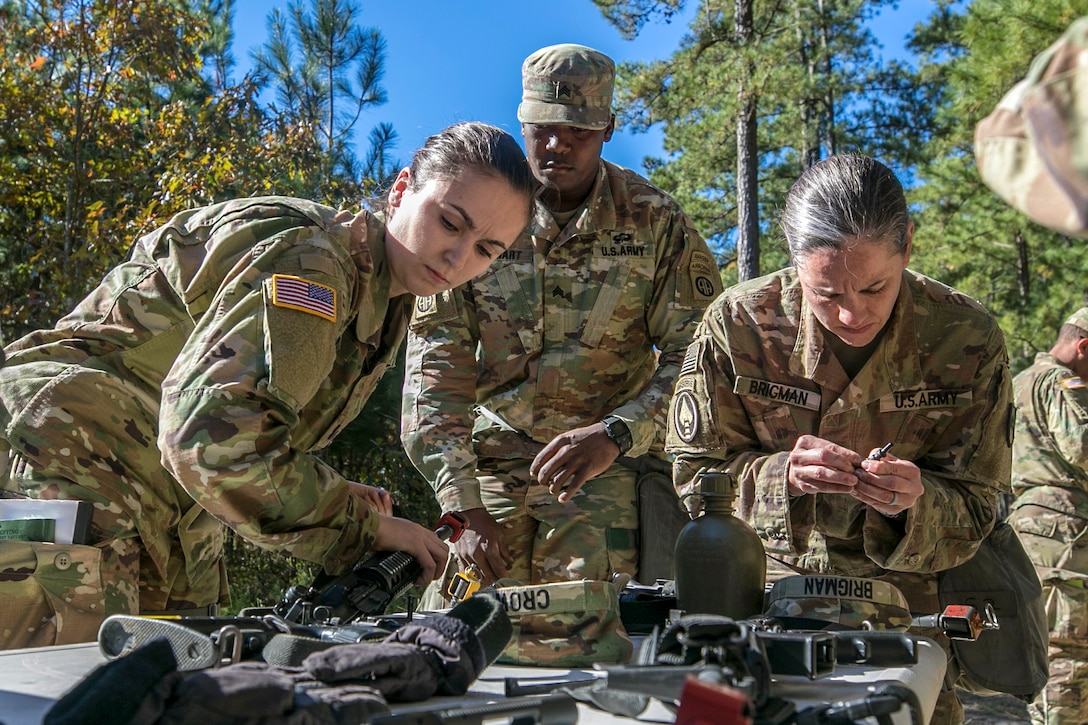 Candidates for the Army’s Expert Field Medical Badge disassemble and reassemble an M4 carbine.