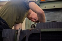 Lance Cpl. Isiah Shafer installs an air conditioning pump on a 7-ton truck at Camp Kinser, Okinawa, Japan October 30, 2018. Shafer, an automotive maintenance technician with Motor Transportation, General Support Maintenance Co., Combat Logistics Regiment 35, 3rd Marine Logistics Group, maintains and inspects vehicles to ensure the vehicles are prepared for any mission. Shafer is a native of Fremont, Nebraska. (U.S. Marine Corps photo by Lance Cpl. Mark Fike)