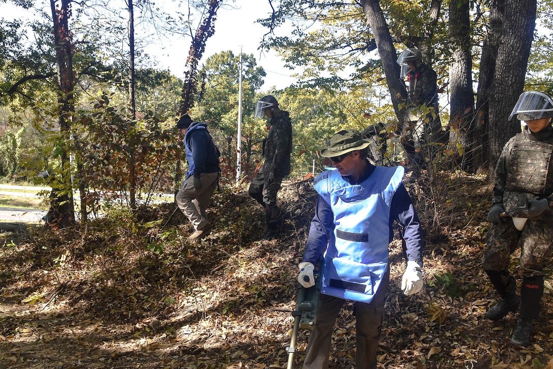 Tom Meeks (far right), a United States  Army Corps of Engineers, Engineering and Support Center quality control representative, surveys an area near the South Korea Demilitarized Zone along with Republic of Korea
Army engineer soldiers during a mine clearing mission, Oct. 19.