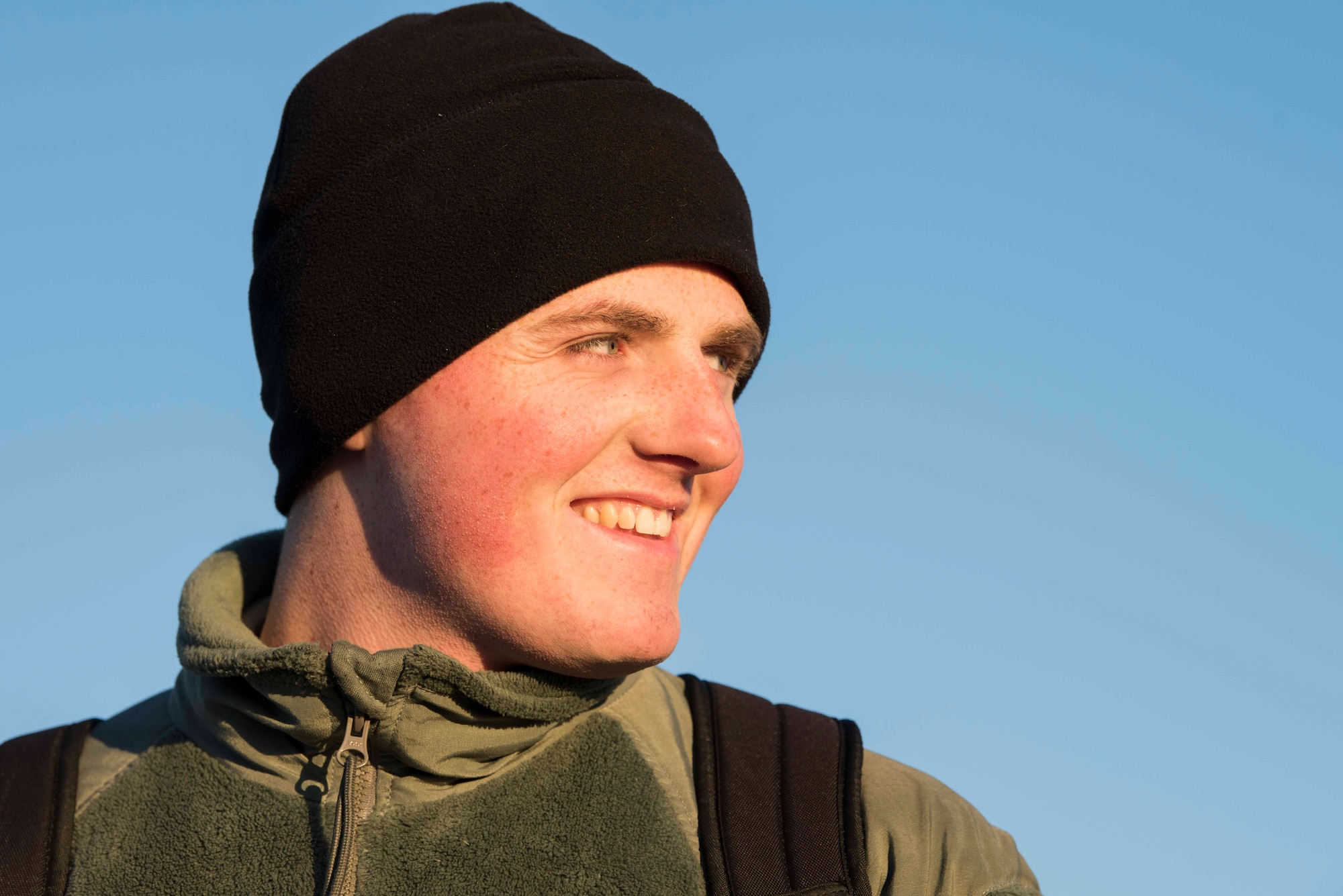 U.S Air Force Airman 1st Class Nathan Bauer, a 35th Aircraft Maintenance Squadron crew chief, smiles during exercise RED FLAG Alaska 19-1 at Eielson Air Force Base, Alaska, Oct. 6, 2018. Team Misawa members wear fleeces and gloves when working on the flight line to protect themselves from the cold weather. (U.S. Air Force photo by Airman 1st Class Collette Brooks)