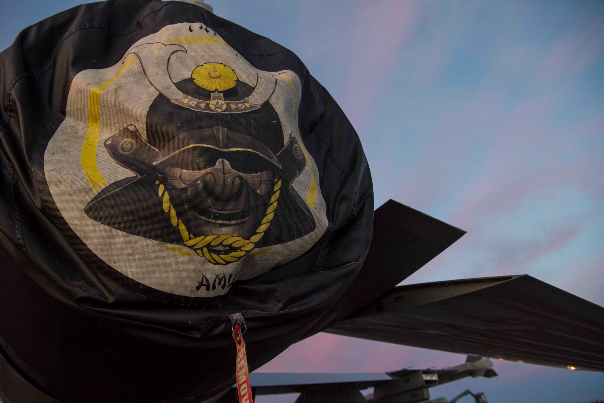 An F-16 Fighting Falcon’s engine cover displays a 14th Fighter Squadron “Samurai” during exercise RED FLAG Alaska 19-1 at Eielson Air Force Base, Alaska, Oct. 12, 2018. The samurai is the mascot that represents the squadron’s strength and resiliency. (U.S. Air Force photo by Airman 1st Class Collette Brooks)