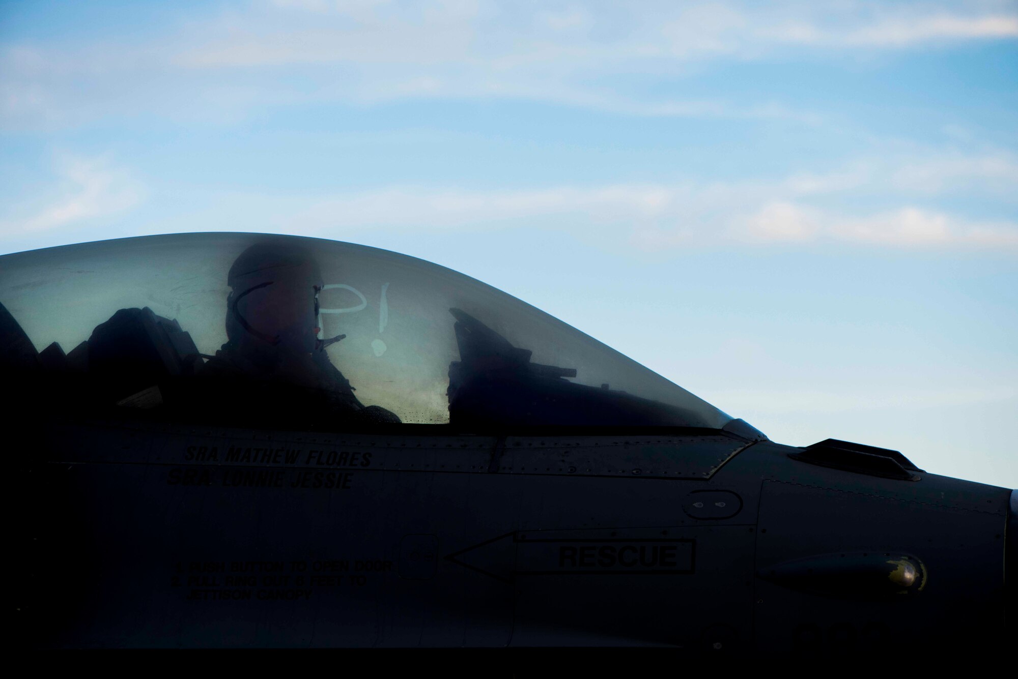 A pilot with the 13th Fighter Squadron writes the letters “CP” on the window of an F-16 Fighting Falcon before a flight during exercise RED FLAG Alaska 19-1 at Eielson Air Force Base, Alaska, Oct. 12, 2018. The letters “CP” stand for Cave Putorium, which is Latin for “fear the weasel.” (U.S. Air Force photo by Airman 1st Class Collette Brooks)