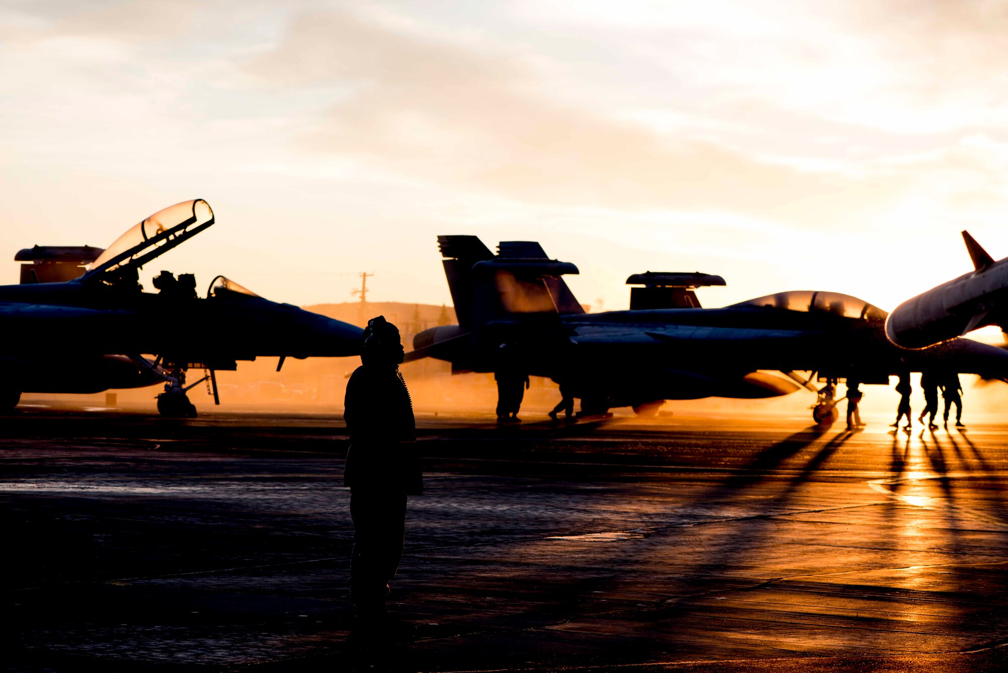 U.S Air Force Airman 1st Class Shaheed Gillespie, a 35th Maintenance Squadron aircraft fuel systems repairer, stands on the flight line during exercise RED FLAG Alaska 19-1 at Eielson Air Force Base, Alaska, Oct. 12, 2018. Maintainers repaired jets alongside joint and multilateral partners from around the world during RF-A 19-1, affording them opportunities to exchange tactics, operations techniques and procedures. (U.S. Air Force photo by Airman 1st Class Collette Brooks)