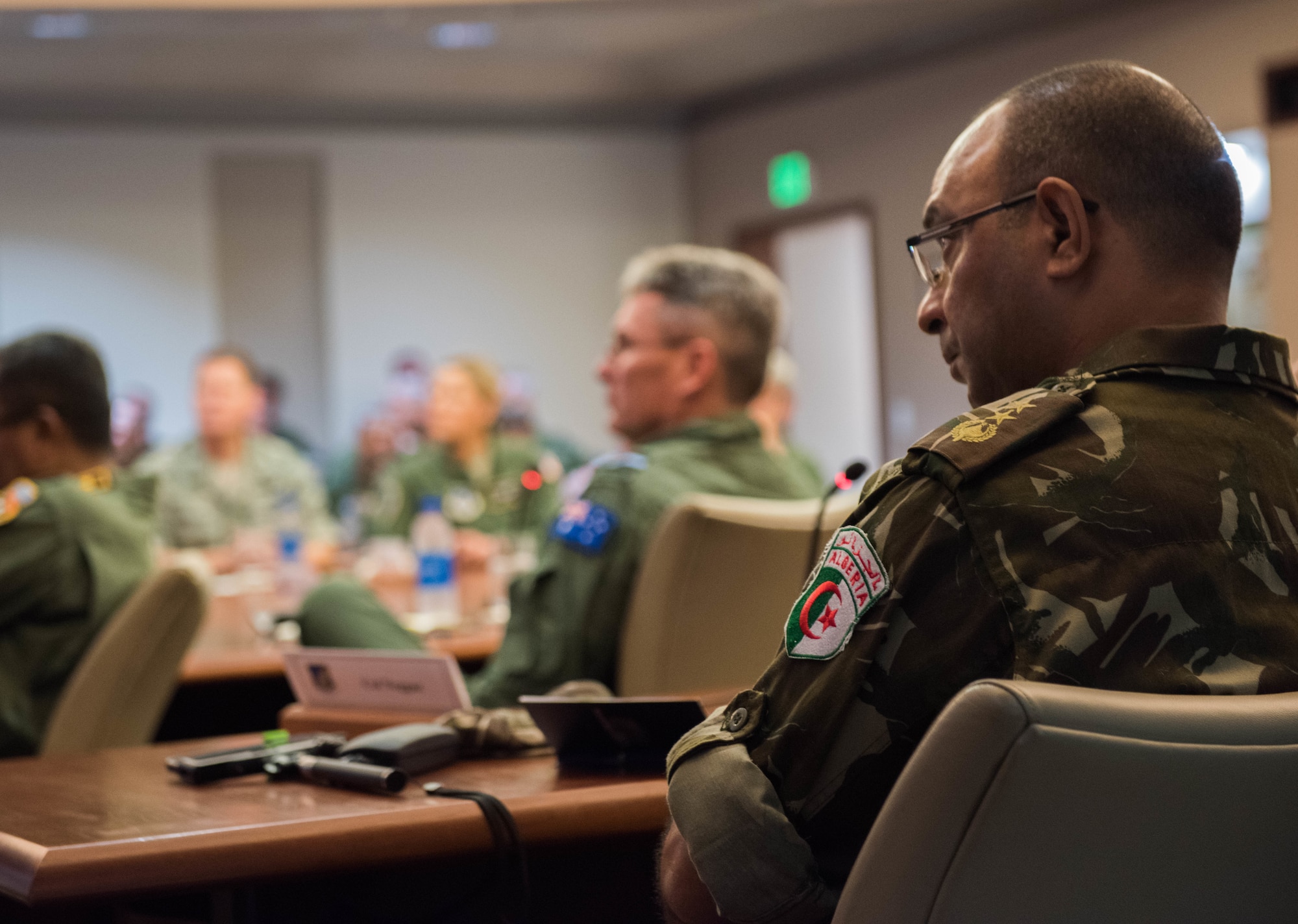 Algerian air force Col. Hadj Neggaz listens to a briefing in the Kenney Conference Room at Headquarters Pacific Air Forces (PACAF) during a foreign attaché tour of Joint Base Pearl Harbor-Hickam, Hawaii, Oct. 23, 2018.