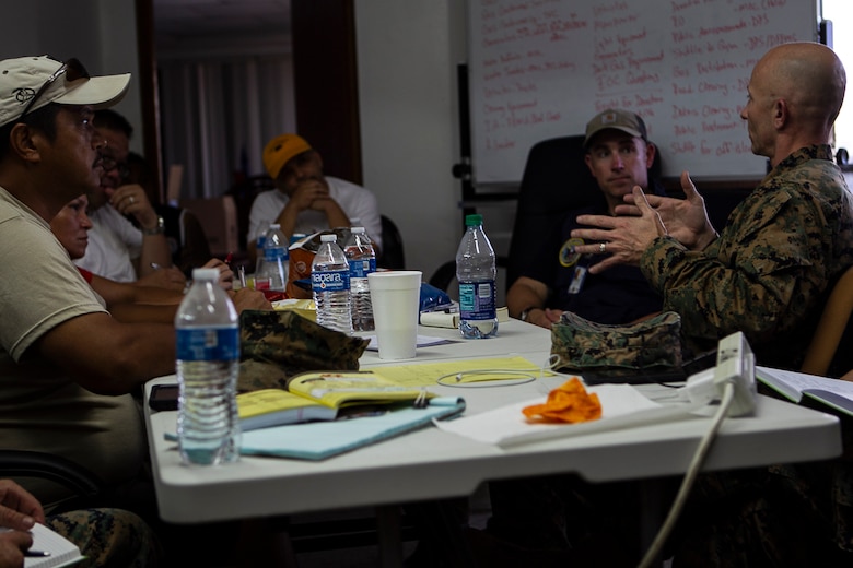 Col. Robert “Bams” Brodie, commander of the 31st Marine Expeditionary Unit, speaks with local elected officials of Tinian, Commonwealth of the Northern Mariana Islands, after arriving to support relief efforts here in the wake of Super Typhoon Yutu, Oct. 29, 2018. Marines with the 31st MEU and Combat Logistics Battalion 31 arrived on Tinian in the wake of Super Typhoon Yutu as part of the U.S. Defense Support of Civil Authorities here. The Marines arrived at the request of CNMI officials and the U.S. Federal Emergency Management Agency to assist relief efforts in the wake of Yutu, the largest typhoon to ever hit a U.S. territory. The 31st MEU, the Marine Corps’ only continuously forward-deployed MEU, provides a flexible force ready to perform a wide-range of military operations across the Indo-Pacific region. (U.S. Marine Corps photo by Gunnery Sgt. T. T. Parish/Released)