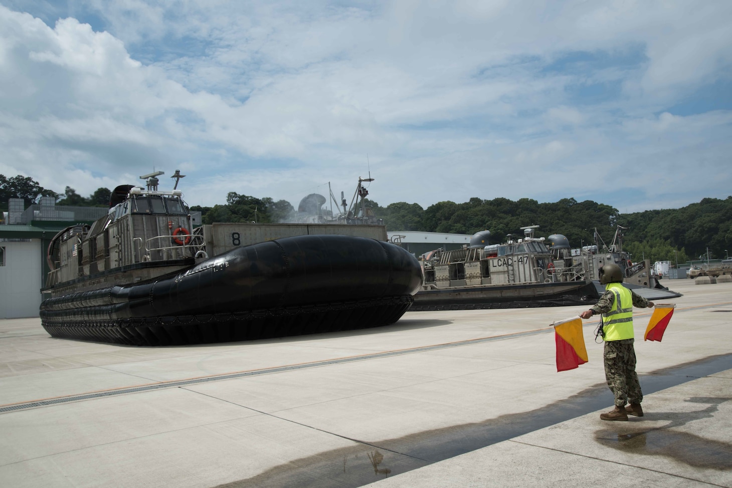 YOKOSE, Japan (Sept. 5, 2017) Seaman Charles Hildebrand, from Lebanon, Penn., directs a landing craft air cushion, assigned to Naval Beach Unit (NBU) 7. NBU 7 is an operational unit that directly contributes to the core capabilities of U.S. maritime sea power and provides the movement of troops, equipment, vehicles and supplies from amphibious ships to shore.