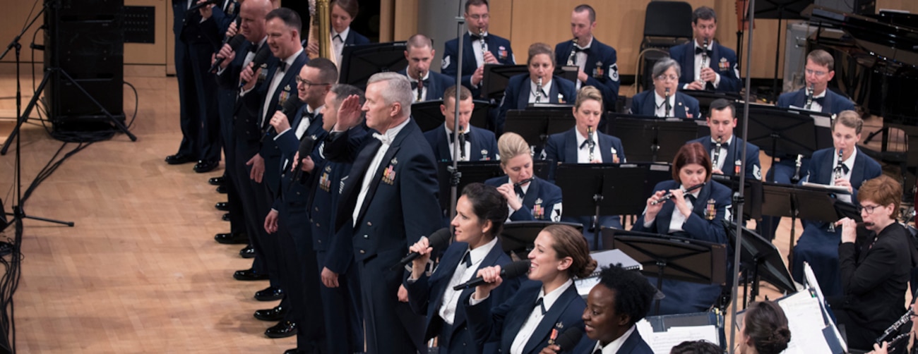 Col. Larry H. Lang, U.S. Air Force Band commander and conductor, salutes the crowd during a performance at the V. Sue Cleveland High Concert Hall in Rio Rancho, N.M., Oct. 17, 2018. After 29 years of service, Lang is scheduled to retire in January. (U.S. Air Force photo by Senior Airman Abby L. Richardson)