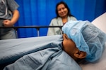 A seven-year-old patient prepares to enter surgery, to repair a cleft palate, aboard the hospital ship USNS Comfort (T-AH 20).