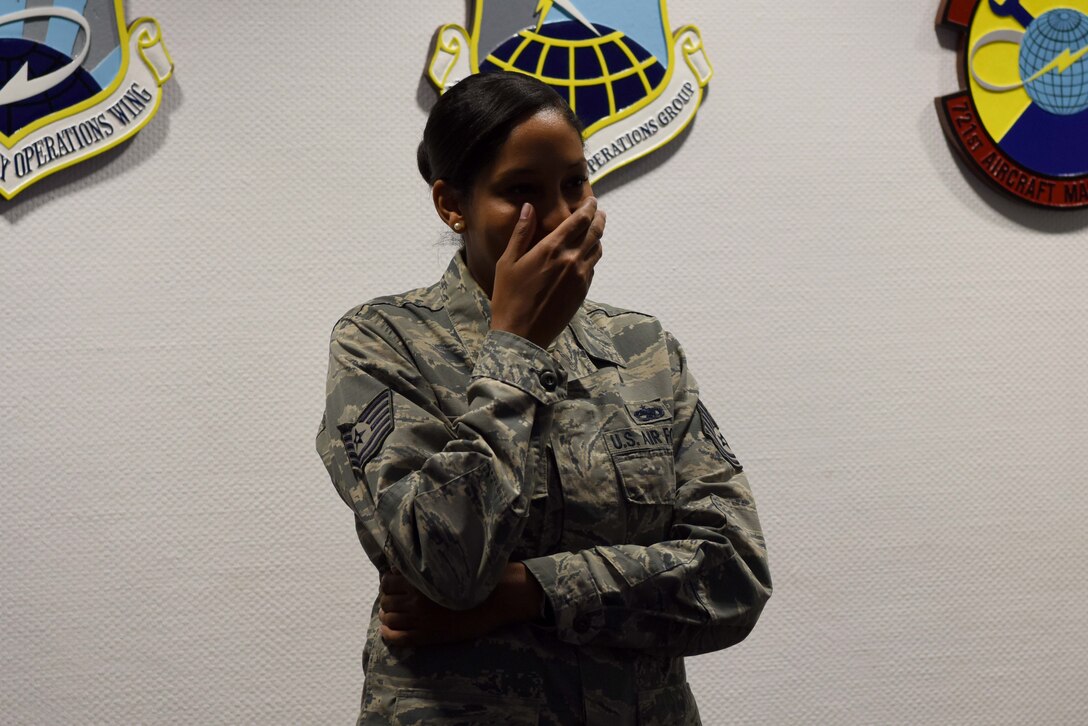 Tech Sgt. Olivia Sandrini, 721st Aircraft Maintenance Squadron, command support staff and programs section chief, shows emotion at a surprise gathering recognizing her pending promotion to 2nd Lt., on Ramstein Air Base, Germany, Nov. 1, 2018. Sandrini was one of five people in the Air Force to be selected by Senior Leader Enlisted Commission Program to be an Air Force officer.