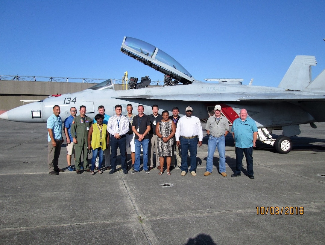 Group shot of employees standing in front of a jet