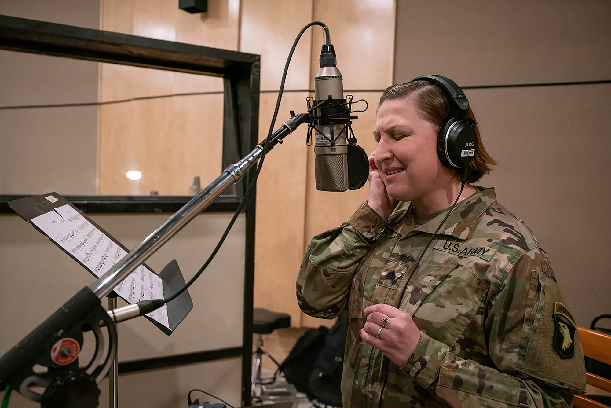 Sgt. Katherine Bolar, a vocalist assigned to the 101st Airborne Band, sings "Light of a Gold Star" at a Nashville based recording studio