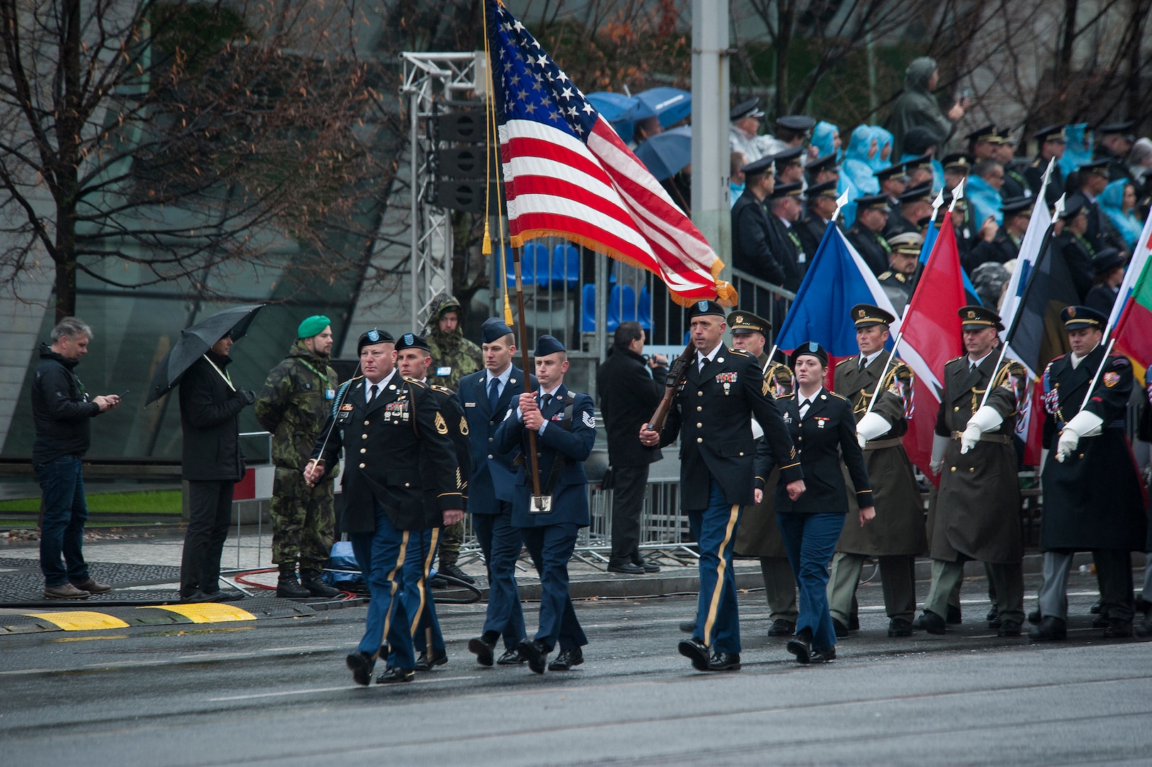 Soldiers and Airmen of the Nebraska and Texas National Guard carry the United States flag while representing the United States during the Czech Republic Military Parade, Oct. 28, 2018, in Prague, Czech Republic. The parade was part of a weekend celebration marking the 100th anniversary of the establishment of Czechoslovakia in 1918. Representing the United States during the parade were: Tech. Sgt. Darren Davlin (Nebraska), Senior Airman Avery Prai (Nebraska), Pfc. Alexa Nelson (Nebraska), Sgt. 1st Class Robb Miller (Texas), Staff Sgt. Eric Halliburton (Texas), and Sgt. Adrian Tejerina (Texas).