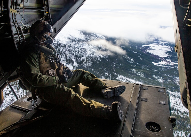 U.S. Marine Cpl. Nicholas Adams, a crew chief, flies aboard a MV-22B Osprey during Trident Juncture 18 at Vaernes Air Base, Norway, Nov. 1, 2018. The exercise enhances the U.S. and NATO Allies’ and partners’ abilities to work together collectively to conduct military operations under challenging conditions. Both the Marine and the MV-22B Osprey are with Marine Medium Tiltrotor Squadron 365, 2nd Marine Aircraft Wing. (U.S. Marine Corps photo by Lance Cpl. Cody J. Ohira)