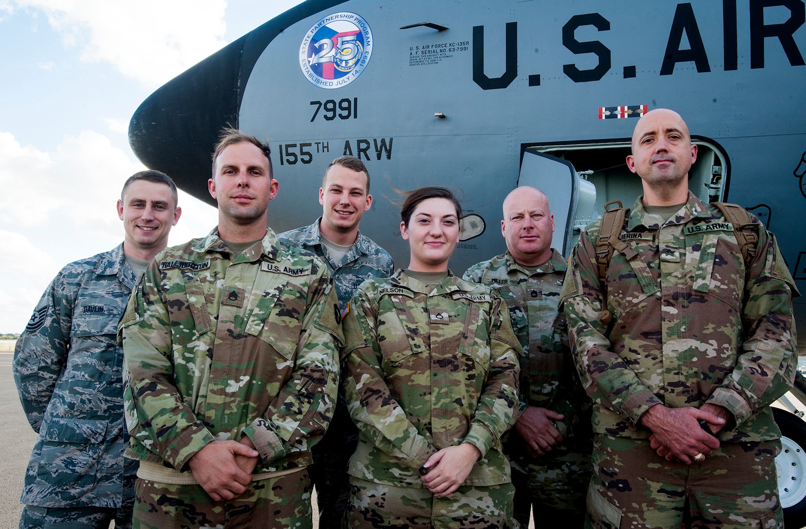 Members of the special combined Nebraska and Texas National Guard color guard pose in front of a Nebraska Air National Guard KC-135R Stratotanker bearing the special 25th State Partnership Program Anniversary logo following an Oct. 29 flight back to the United States from the Czech Republic where the team marched in the Oct. 28 Czech Centennial Military Parade in Prague. Pictured are, from left, Tech. Sgt. Darren Davlin, Nebraska Air National Guard; Staff Sgt. Eric Halliburton, Texas Army National Guard; Senior Airman Avery Prai, Nebraska Air National Guard; Pfc. Alexa Nelson, Nebraska Army National Guard; Sgt. 1st Class Robb Miller, Texas Army National Guard; and Sgt. Adrian Tejerina, Texas Army National Guard.