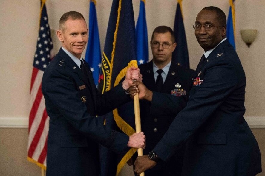 U.S. Air Force Lt. Col. David H. Donatelli II, outgoing 608th Strategic Operations Squadron commander, relinquishes command to Maj. Gen. James Dawkins Jr., 8th Air Force and J-GSOC commander, during a deactivation ceremony at Barksdale Air Force Base, La., Oct. 15, 2018. The 608th STOS has supported joint operations since June 4, 2004. (U.S. Air Force photo by Airman 1st Class Tessa Corrick)