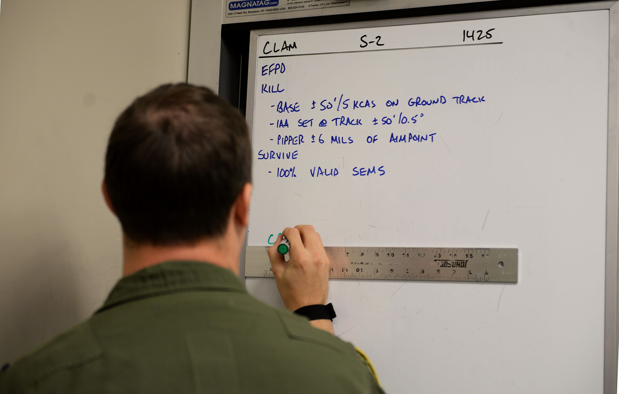 Capt. Travis Vada, 49th Fight Training Squadron upgrading instructor pilot, writes information onto a white board at the 49th FTS Oct. 30, 2018, on Columbus Air Force Base, Mississippi. The standard set by the 49th FTS not only aids the Air Force, it ensure the pilots are highly capable of their job with the most professional attitude needed to accomplish the mission. (U.S. Air Force photo by Airman Hannah Bean)