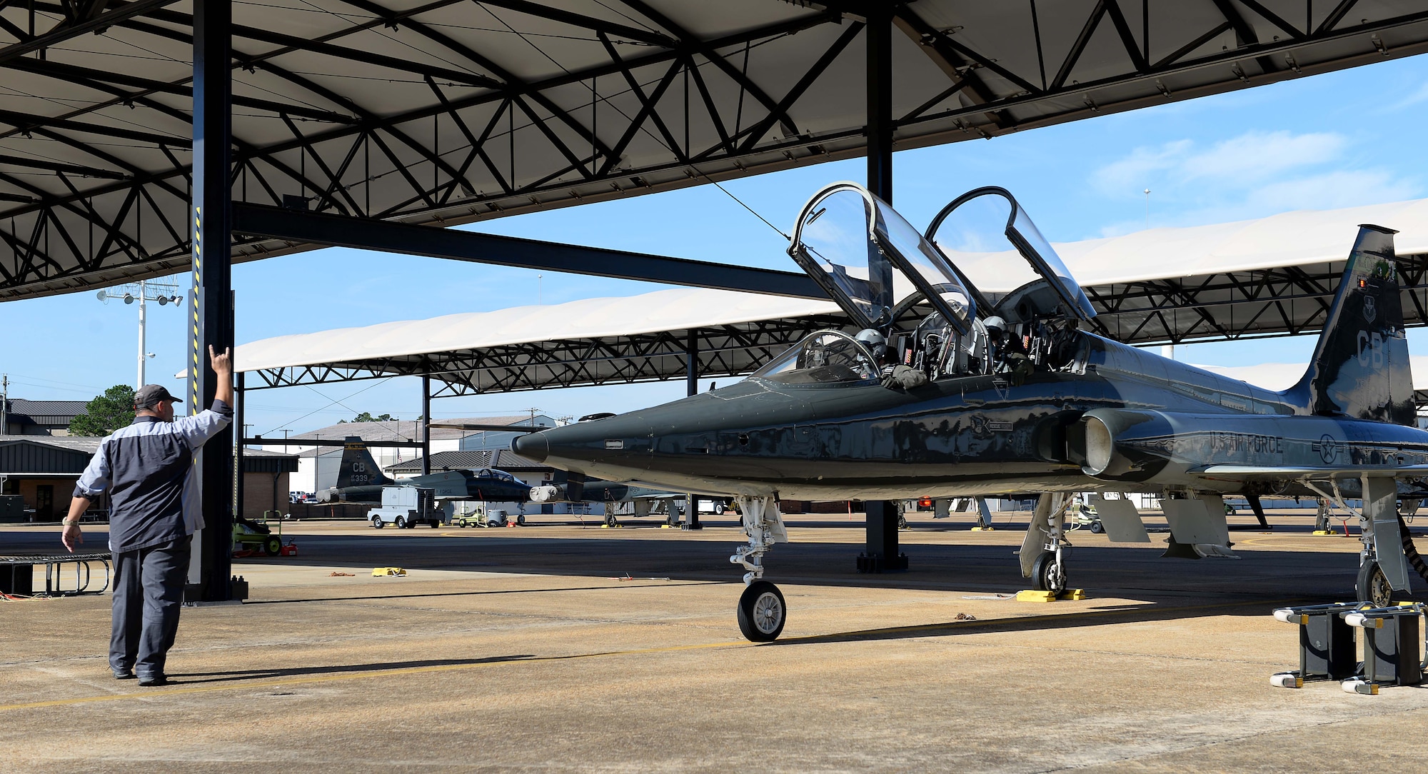 Eric Griggs, a Vertex T-38C Talon serviceman, aids 1st Lt. Tyler Hansen, 49th Fighter Training Squadron student pilot, and Capt. Cole Stegeman, 49th FTS upgrading instructor pilot, prepare to fly a training sortie Oct. 30, 2018, on Columbus Air Force Base, Mississippi. Pilots and servicemen dedicate a great deal of time and effort to ensure the aircraft is fully prepared for flight and soundly running. (U.S. Air Force photo by Airman Hannah Bean)