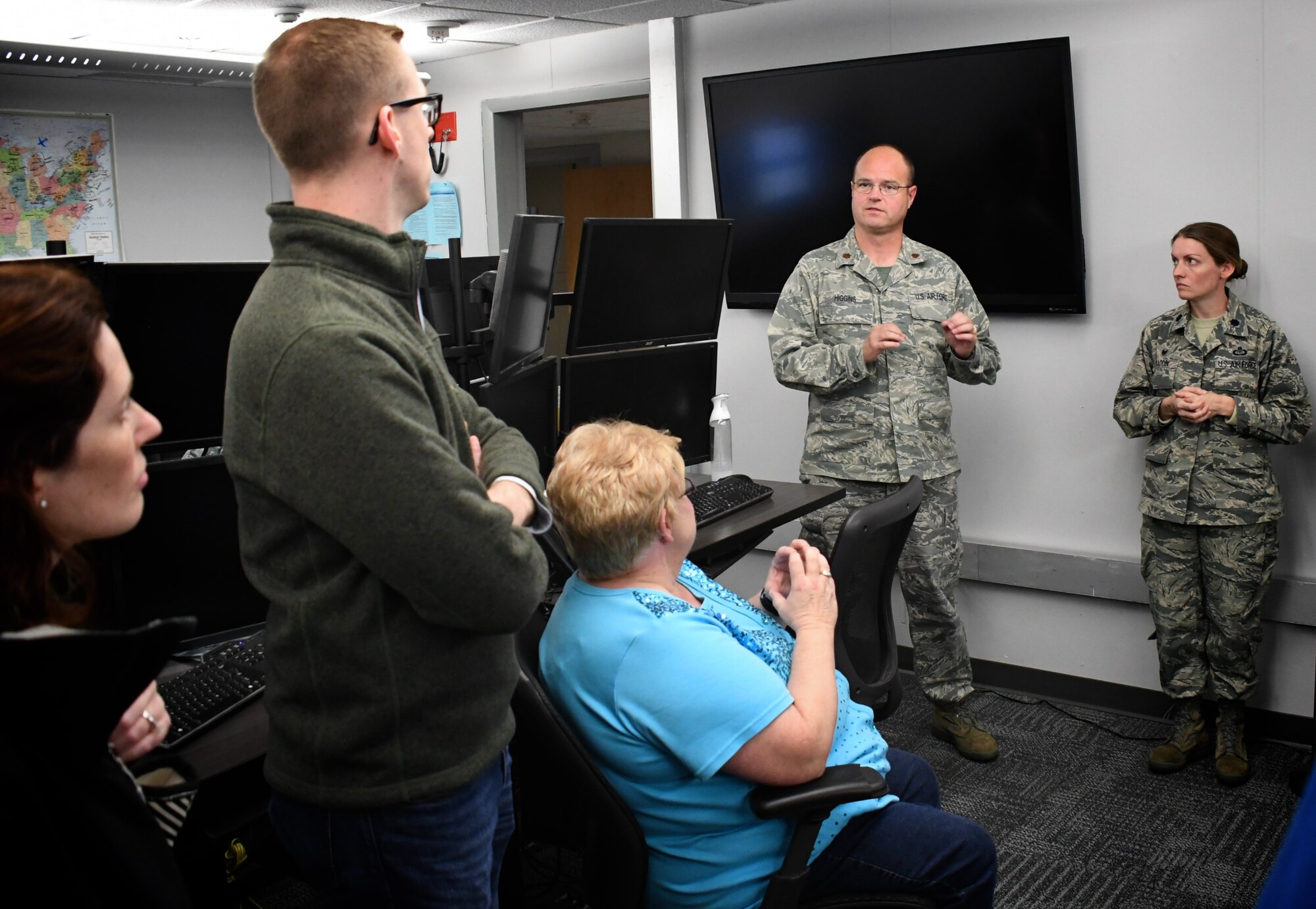Maj. Chris Higgins and Lt. Col. Laura Madden, 12th Operational Weather Flight, explains their weather prediction roles to civilian employers visiting Scott Air Force Base, Illinois on October 13, 2018. The event was Boss Day and employers were the guests.  

They learned that the Air Force has always been the backup agency for the Storm Prediction Center (SPC). Historically, it was on May 1, 2009 that the mission came to the 15th Operational Weather Squadron. 

The SPC handed off support to Airmen like Maj. Higgins on 26 March that year, and even though SPC has a lot of other weather speciality products they produce, the ones that 12 OWF are in charge of are the convective outlooks days and weather watches. SPC is located in Norman, Oklahoma, so if they ever have to shelter for a tornado the Storm Prediction Center backup team is called in to take over. Maj. Higgins spent time on the phones with weather managers in various states during the event. Boss Day showed off various areas of the 932nd Airlift Wing and Scott Air Force Base.  (U.S. Air Force photo by Lt. Col. Stan Paregien)