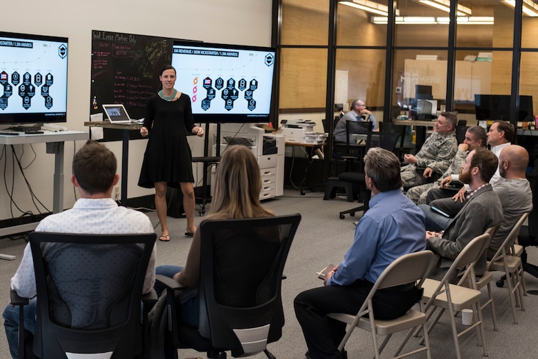 Capt. Samantha Snabes, Squadron Officer School graduate, speaks to Airmen and local community members at MGMWERX, Oct. 24, 2018, in Montgomery, Alabama. MGMWERX is a collaborative initiative between Air University, the City of Montgomery, The Montgomery Chamber of Commerce and Montgomery County to foster innovative thinking and problem solving. (U.S. Air Force photo by Senior Airman Alexa Culbert)