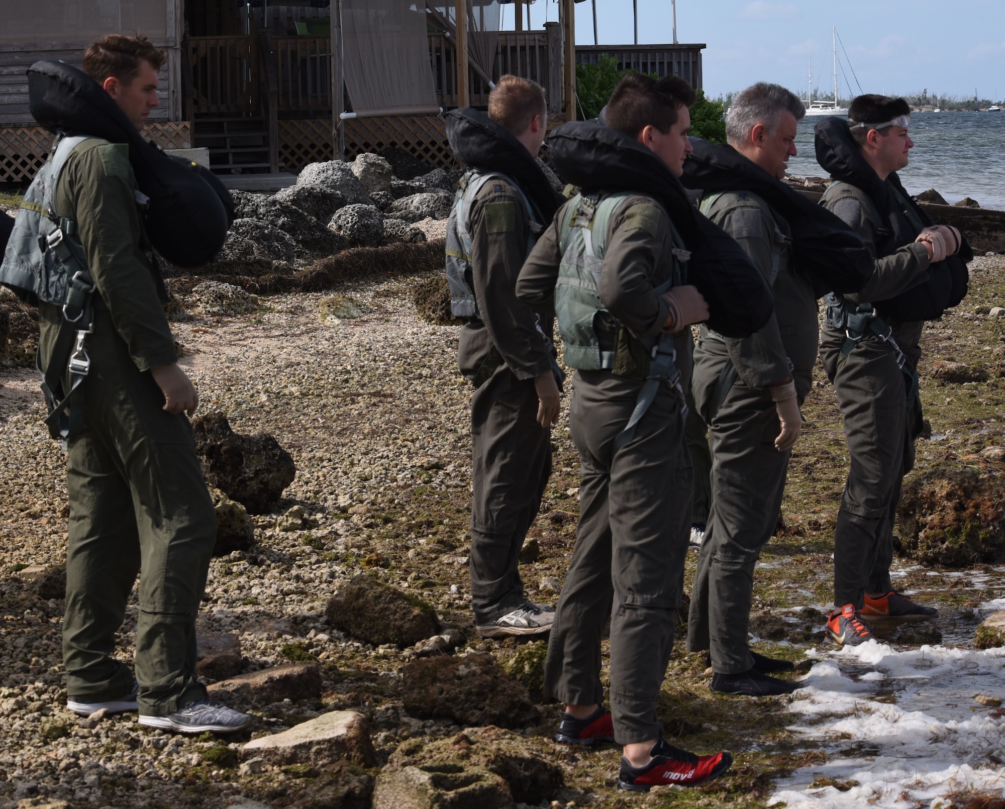 Pilots from the 355th Fighter Squadron prepare to go through water survival training, Oct. 28, 2018, at Naval Air Station Key West, Florida. The pilots, who are required to go through the course every three years, learn how to escape parachute entanglements and survive in a one-man raft in case of emergency, which helps them stay combat and deployment-ready. (U.S. Air Force photo by Tech. Sgt. Charles Taylor)