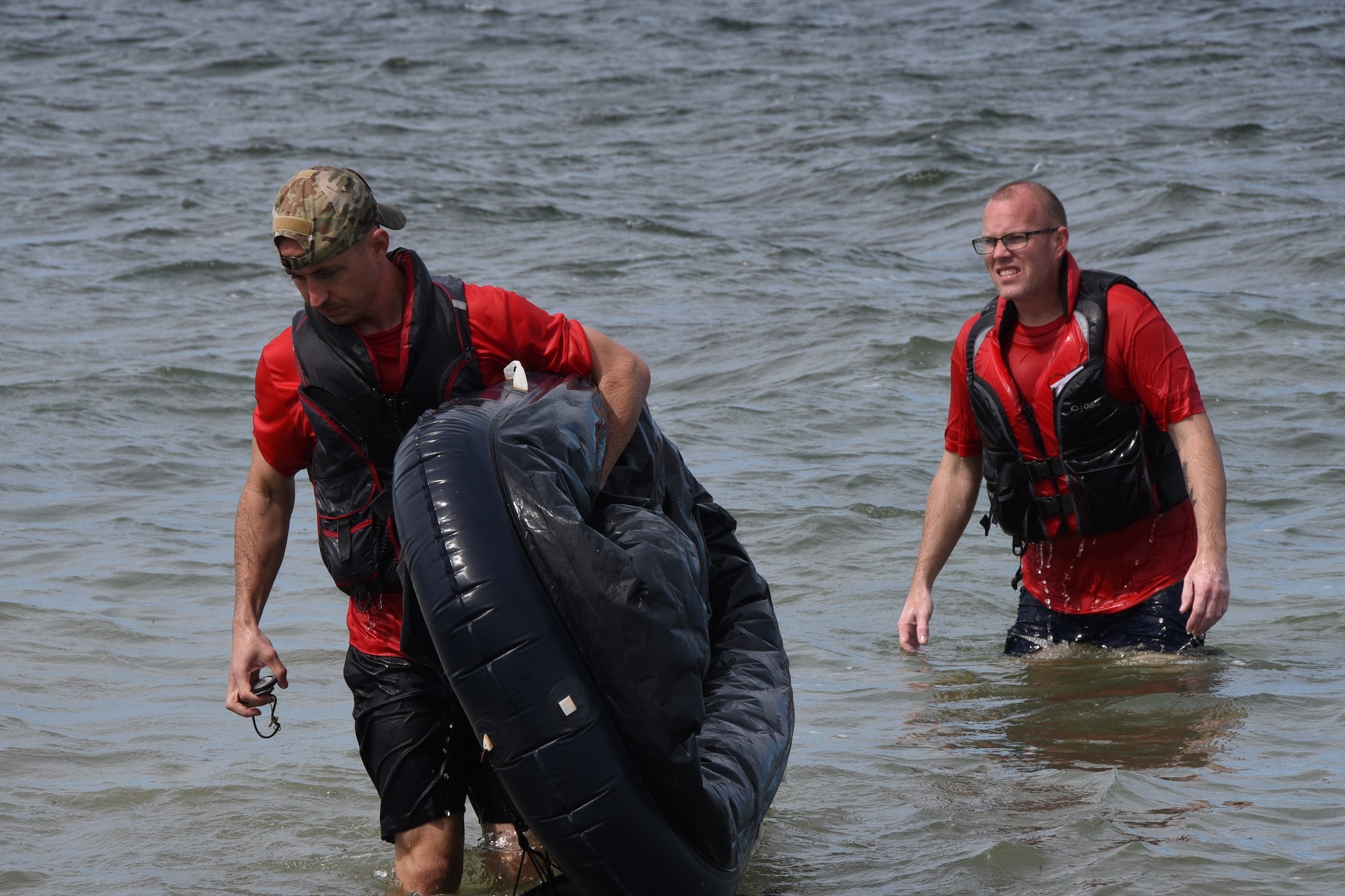 Master Sgt. Rudolph Panacci, and Tech. Sgt. Jeremy Beachy, both 301st Operations Support Flight Aircrew Flight Equipment technicians, return to shore from water survival training, Oct. 28, 2018, at Naval Air Station Key West, Florida. AFE conducted the training, which is required for pilots to accomplish every three years, and taught techniques such as parachute entanglement escape and surviving in a raft in case of emergency. (U.S. Air Force photo by Tech. Sgt. Charles Taylor)