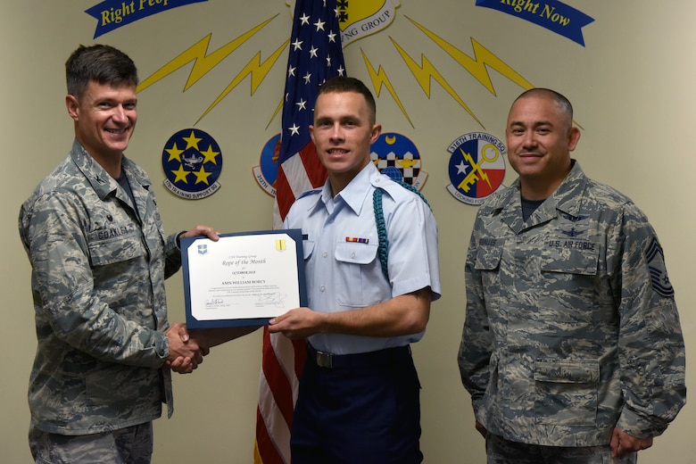 U.S. Air Force Col. Thomas Coakley, 17th Training Group commander, presents the 17th Training Group Rope of the Month to Airman William Borcy, 312th Training Squadron student, at Brandenburg Hall on Goodfellow Air Force Base, Texas, Nov. 2, 2018. Military Training Leaders present ropes to Airmen who display exceptional leadership qualities to lead their peers. (U.S. Air Force photo by Airman 1st Class Zachary Chapman/Released)