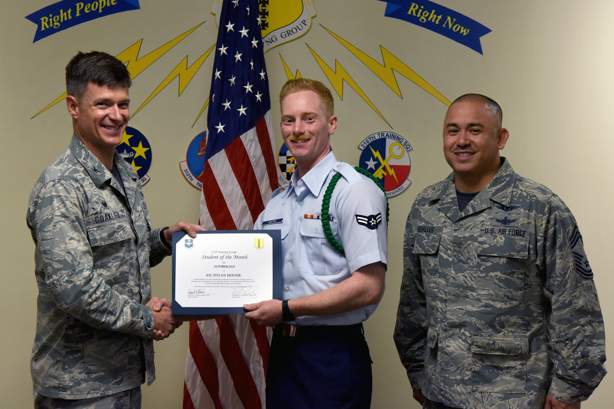 U.S. Air Force Col. Thomas Coakley, 17th Training Group commander, presents the 315th Training Squadron Student of the Month award to Airman 1st Class Dylan Heeter, 315th TRS student, at Brandenburg Hall on Goodfellow Air Force Base, Texas, Nov. 2, 2018. The 315th TRS’s vision is to develop combat-ready intelligence, surveillance and reconnaissance professionals and promote an innovative squadron culture and identity unmatched across the U.S. Air Force. (U.S. Air Force photo by Airman 1st Class Zachary Chapman/Released)