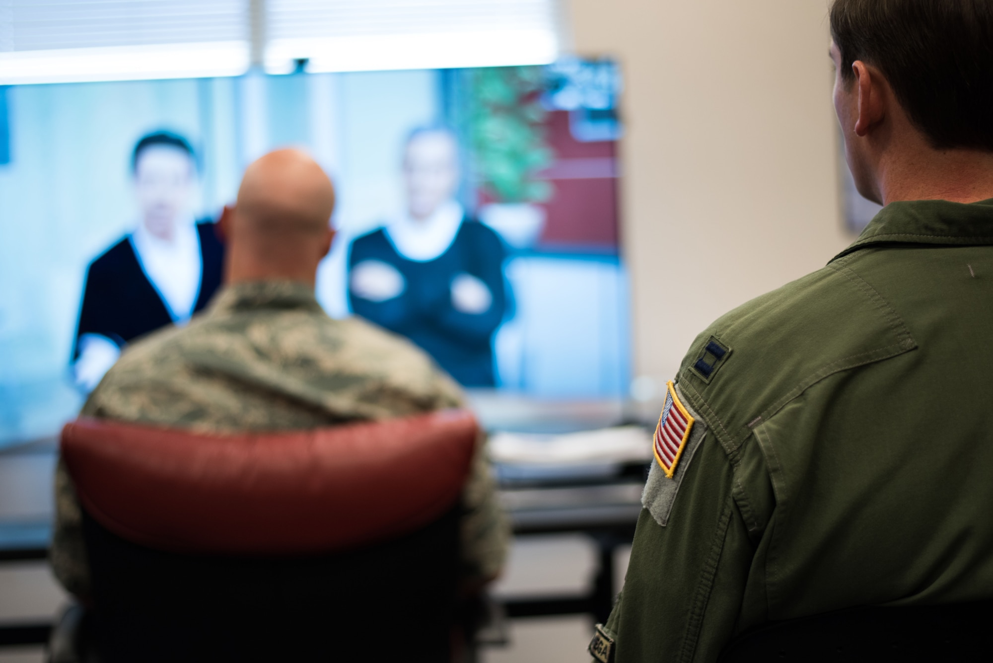 A Squadron Officer School student observes his classmate participating in the Mixed Reality Learning Experience program Oct. 18, 2018, at Maxwell Air Force Base, Alabama. Two students out of a 14-person flight engage in a simulated conversation in the MRLx to experience the type of discussions they will face while in leadership positions. (U.S. Air Force photo by Senior Airman Alexa Culbert)