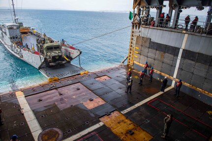 OKINAWA, Japan (Oct. 30, 2018) Sailors and Marines, attached to the 31st Marine Expeditionary Unit (MEU), offload equipment and personnel into the amphibious dock landing ship USS Ashland (LSD 48) in preparation to supporting Defense Support to Civil Authorities (DSCA) efforts. Sailors and Marines from Ashland, part of the Wasp Amphibious Ready Group and 31st Marine Expeditionary Unit team, are preparing to provide Department of Defense support to the Commonwealth of the Northern Mariana Islands’ civil and local officials as part of the FEMA-supported Typhoon Yutu recovery efforts. (U.S. Navy photo by Mass Communication Specialist 2nd Class Joshua Mortensen)