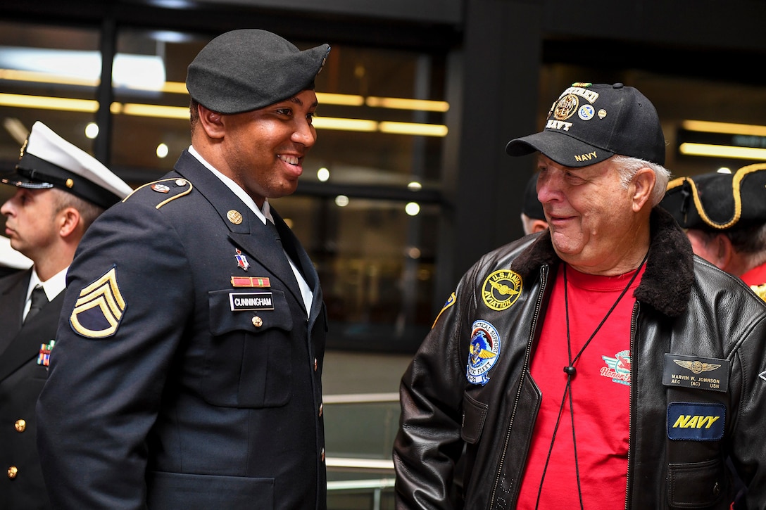 A soldier shares a laugh with a veteran.