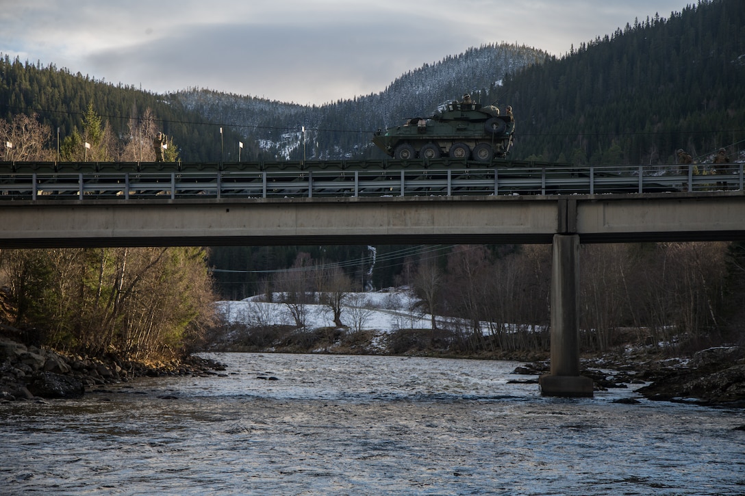Light Armored Vehicles with 2nd Light Armored Reconnaissance, cross a medium girder bridge as part of Exercise Trident Juncture 18 near Voll, Norway, Oct. 30, 2018. The bridge construction enables ground units to complete a gap crossing during the exercise, which is one of the general engineering tasks 2nd Marine Logistics Group provides to the Marine Air-Ground Task Force. Trident Juncture 18 enhances the U.S. and NATO Allies’ and partners’ abilities to work together collectively to conduct military operations under challenging conditions. (U.S. Marine Corps photo by Lance Cpl. Scott R. Jenkins)