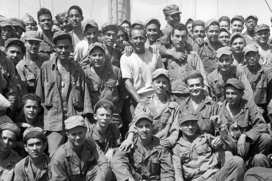 A group of service members pose for a photo.