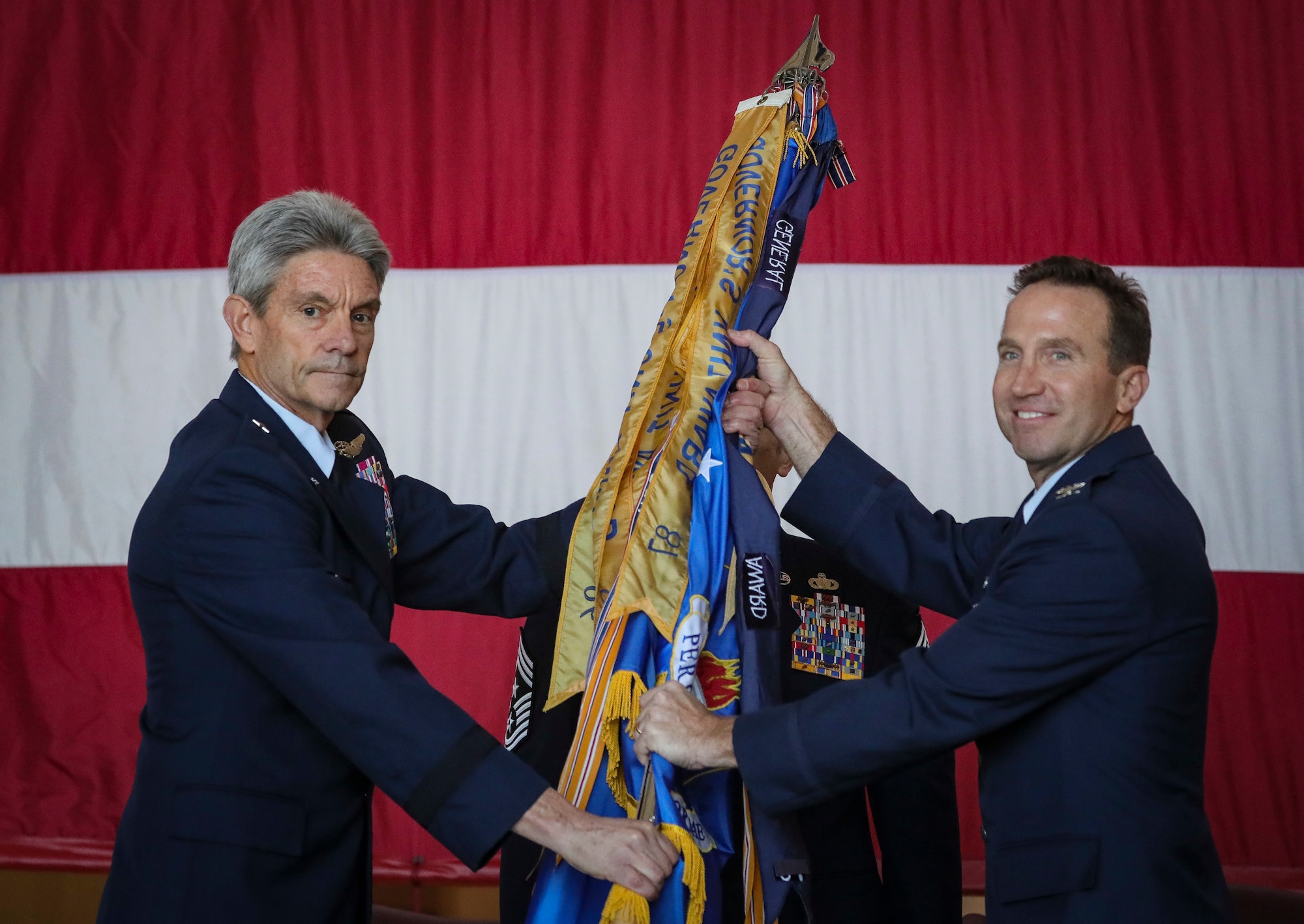 Brig. Gen. Kevin J. Keehn, left, commander of the New Jersey Air National Guard, passes the guidon to incoming 108th Wing commander Col. John M. Cosgrove during a change of command ceremony on Joint Base McGuire-Dix-Lakehurst, N.J., Nov. 4, 2018.