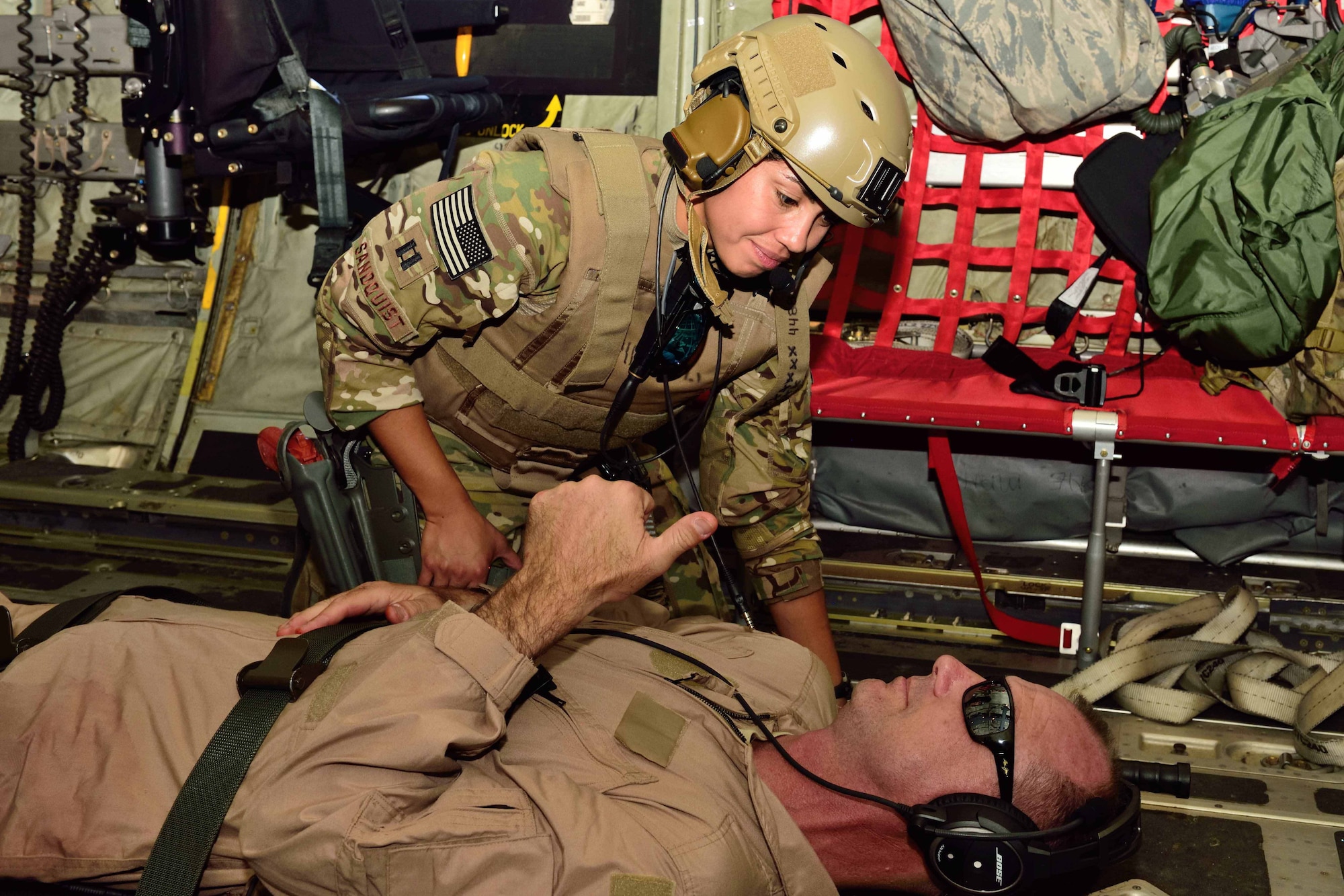 Capt. Alyssa Sandquist, 36th Aeromedical Evacuation Squadron flight nurse, checks on Capt. Jonathan Marek, a 36th AES flight nurse playing the part of an “injured” patient being airlifted from Camp Shelby to Keesler Air Force Base, Mississippi, during an exercise Nov. 4, 2018. The 403rd Wing, of which the 36th AES is a part, participated in an exercise during the November 2018 Unit Training Assembly to test their ability to survive and operate in a deployed environment. (U.S. Air Force photo by Tech. Sgt. Ryan Labadens)