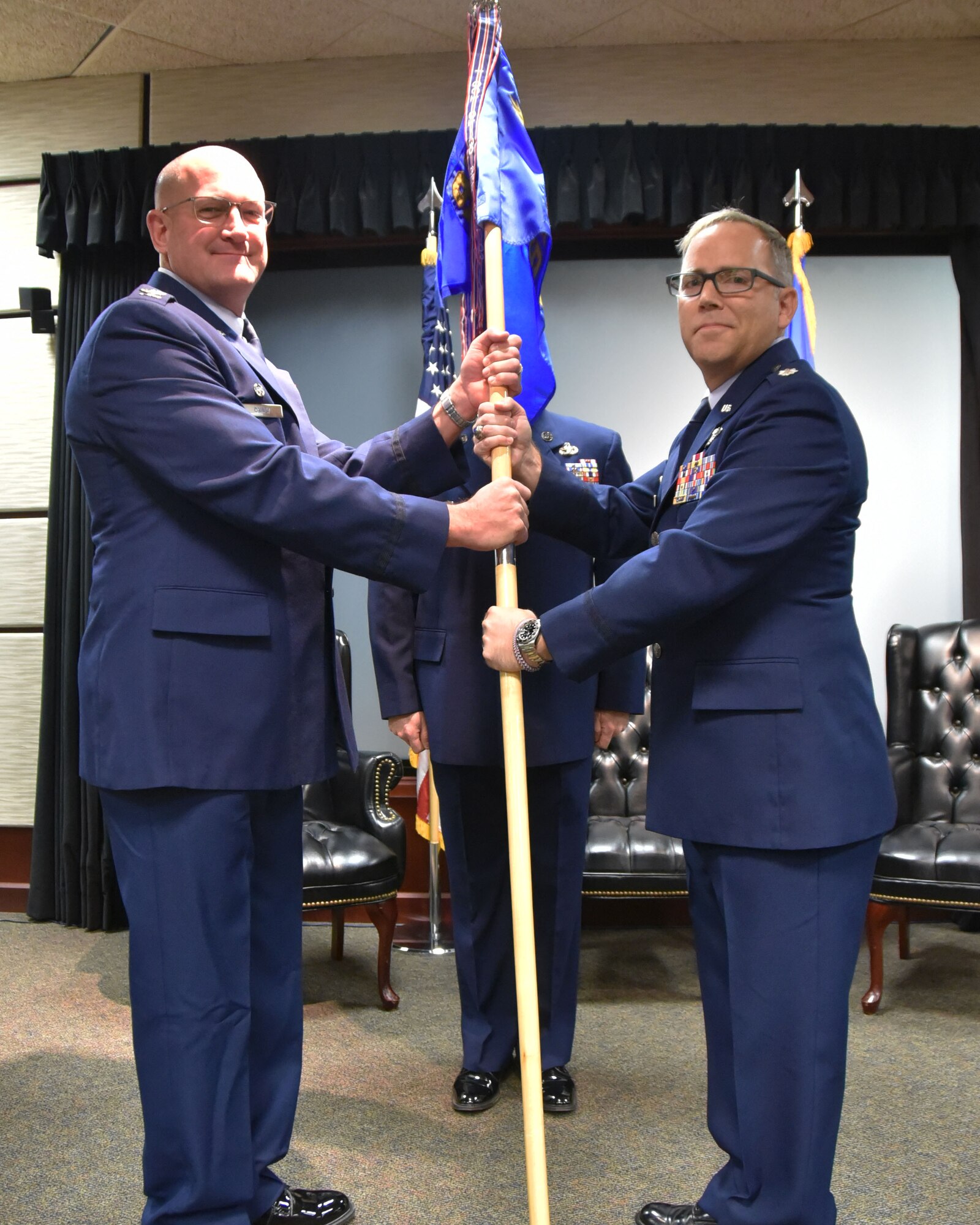 (Left to right) Col. Kevin Rainey, 931st Operations Group commander, hands the guidon to Lt. Col Matthew Ghormley, incoming 931st Operations Support Squadron commander, during a change of command ceremony Nov. 4, 2018, McConnell Air Force Base, Kan.  Prior to this assignment, Ghormley was assigned to the Programs and Requirements Division, Office of Air Force Reserve, at the Pentagon, Va.  (U.S. Air Force photo by Tech. Sgt. Abigail Klein)