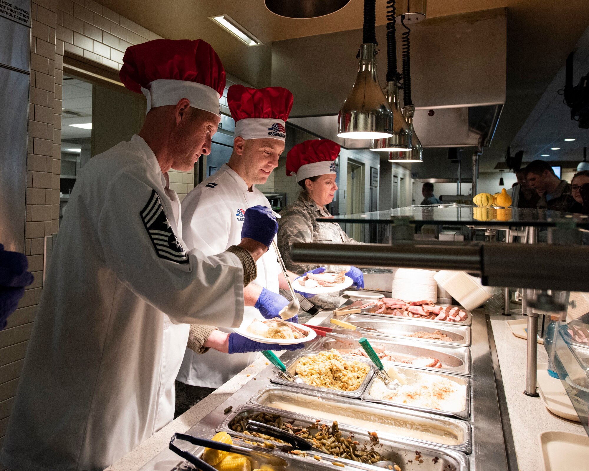 Leaders from the 141st Air Refueling Wing serve a holiday meal to Airmen at the Warrior Dining Facility Nov. 3, 2018 on Fairchild Air Force Base, Wash. As part of the holiday season, commanders, chiefs, and first sergeants volunteer their time to take part in serving a traditional holiday meal every November drill weekend. (U.S. Air National Guard photo by Staff Sgt. Rose M. Lust)