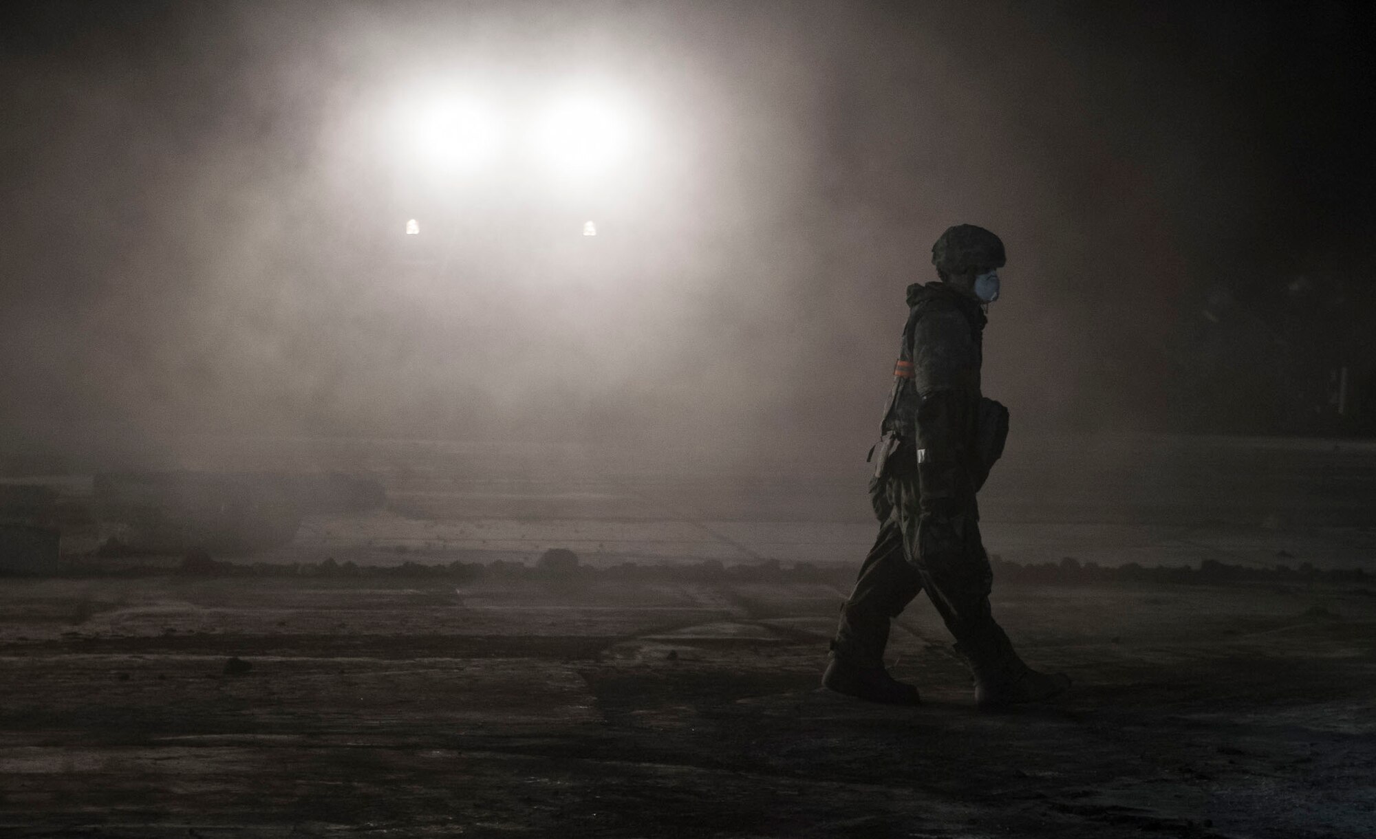 An Airman with the 374th Civil Engineer Squadron walks across a concrete slab to assist with Rapid Airfield Damage Repair (RADR) during Exercise Beverly Morning 18-04, at Yokota Air Base, Japan
