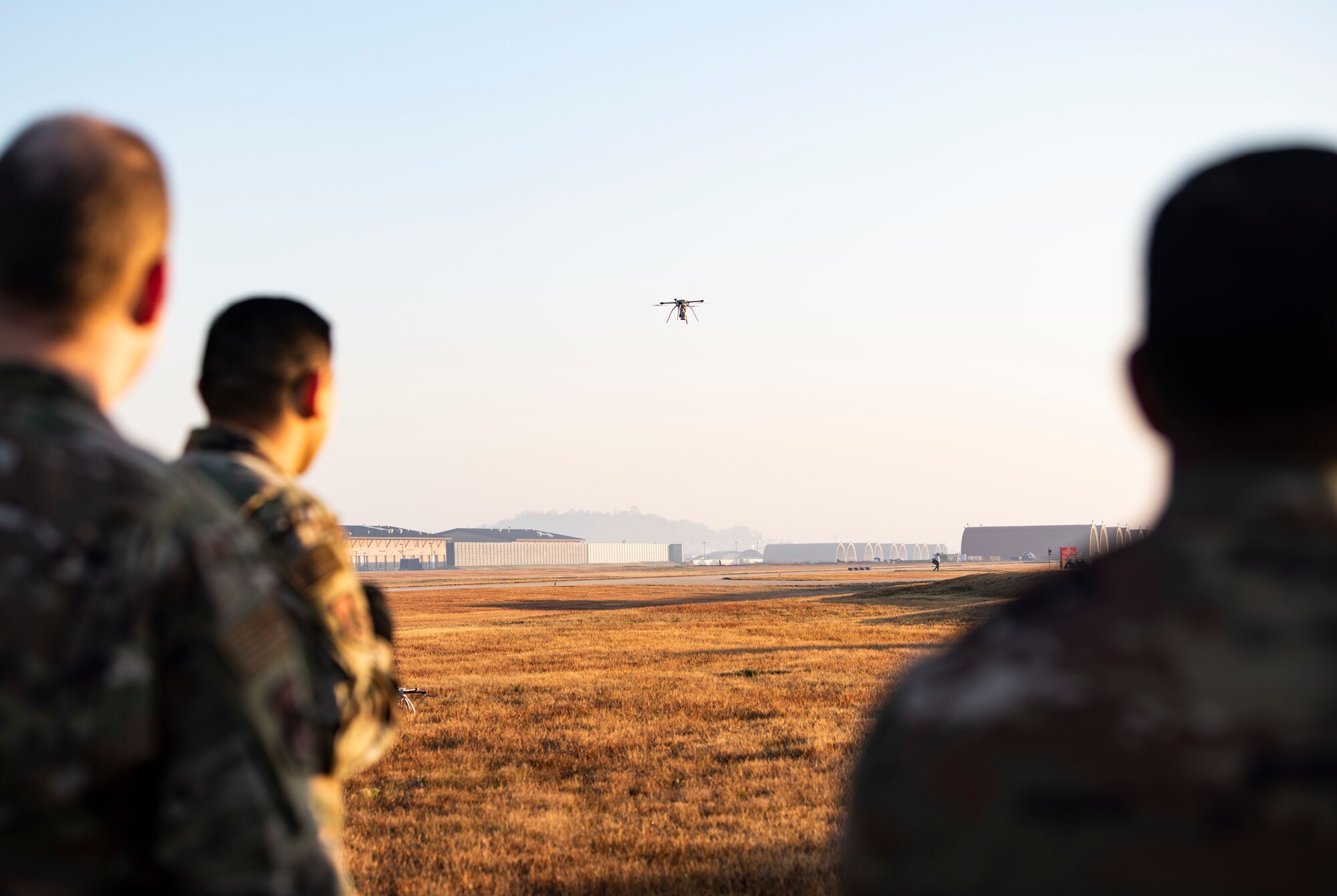 U.S. Air Force Airmen from the 8th Civil Engineer Squadron, observe a quadcopter taking off at Kunsan Air Base, Republic of Korea, Nov. 2, 2018. The 8th CES trains using small, unmanned aerial systems to survey the airfield at a quicker pace and larger scale, honing a capability that can be used in the aftermath of natural disasters to survey damage. (U.S. Air Force photo by Senior Airman Stefan Alvarez)
