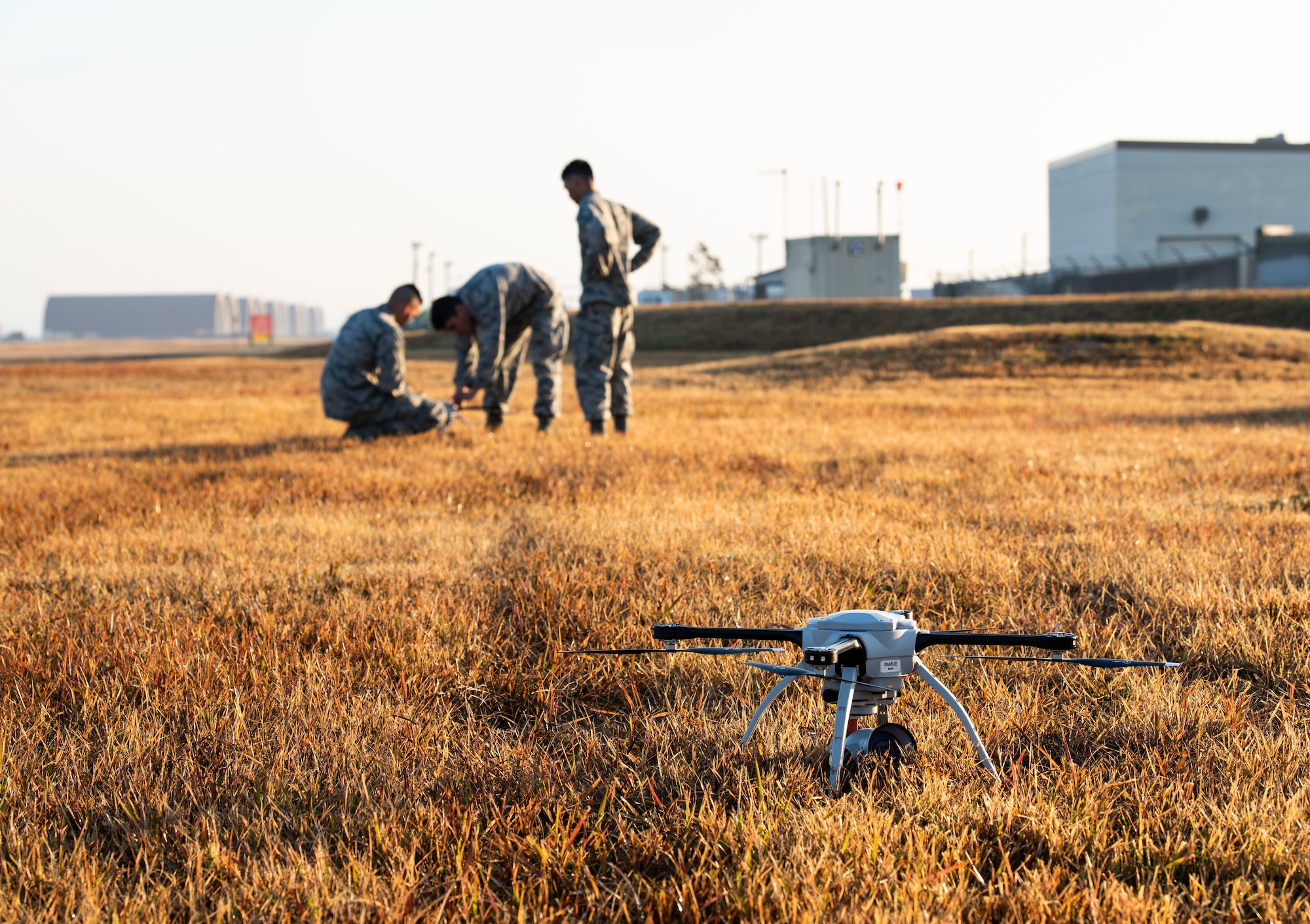 U.S. Air Force engineering technicians from the 8th Civil Engineer Squadron, replace the battery of a quadcopter at Kunsan Air Base, Republic of Korea, Nov. 2, 2018. The 8th CES is piloting a Rapid Airfield Damage Assessment System program to see how viable utilizing small unmanned aerial systems will be, instead of sending personnel into potentially hazardous environments to survey damage to the base. (U.S. Air Force photo by Senior Airman Stefan Alvarez)