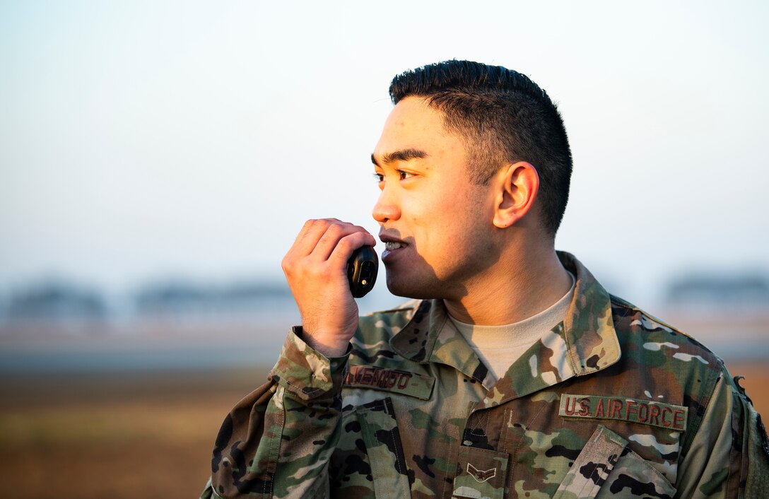 U.S. Air Force Airman 1st Class Alexander Avenido, 8th Civil Engineer Squadron engineering technician, relays the location of a quadcopter on Kunsan Air Base, Republic of Korea, Nov. 2, 2018. The 8th CES trains using small, unmanned aerial systems to survey the airfield at a quicker pace and larger scale, honing a capability that can be used in the aftermath of natural disasters to survey damage. (U.S. Air Force photo by Senior Airman Stefan Alvarez)