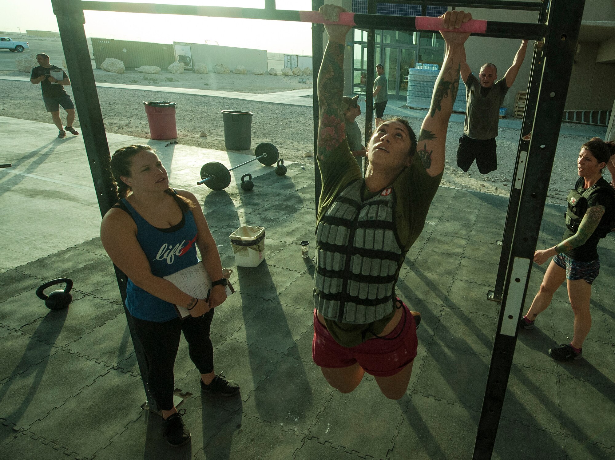 U.S. Air Force Tech. Sgt. Emily Albonetti, center, 746th Expeditionary Airlift Squadron intelligence analyst,  participates in the 2018 EOD 133 Memorial Workout Nov. 4, 2018, at Al Udeid Air Base, Qatar. The event was held in honor of U.S. Army Sgt. James Slape, 430th Explosive Ordnance Company, who was killed by an improvised explosive device Oct. 4, 2018. (U.S. Air Force photo by Tech. Sgt. Christopher Hubenthal)