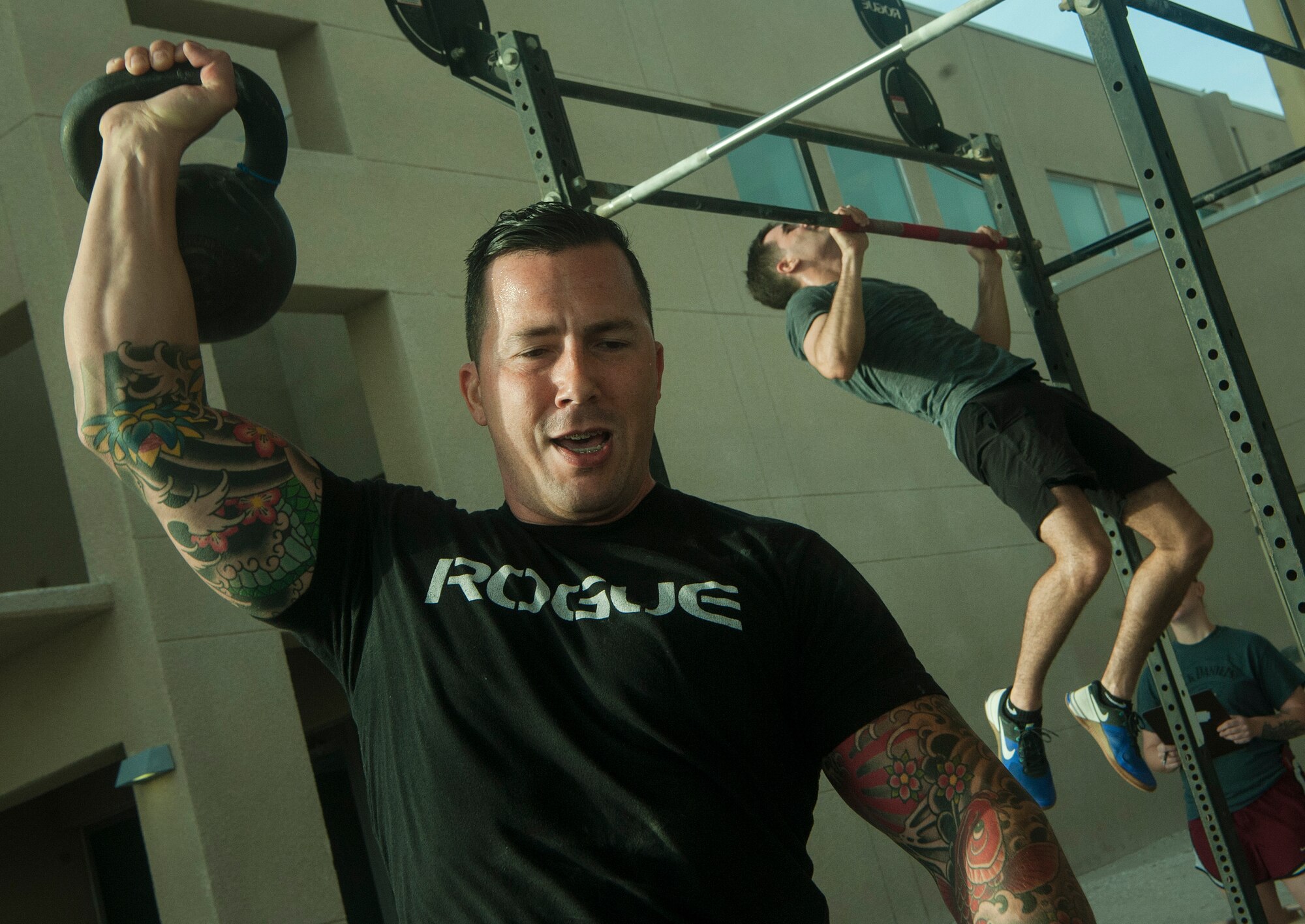 U.S. Air Force Master Sgt. Casey Farr, 379th Air Expeditionary Wing weapons safety manager, lifts a kettle bell during the 2018 EOD 133 Memorial Workout Nov. 4, 2018, at Al Udeid Air Base, Qatar. The event was held in honor of U.S. Army Sgt. James Slape, 430th Explosive Ordnance Company, who was killed by an improvised explosive device Oct. 4, 2018. (U.S. Air Force photo by Tech. Sgt. Christopher Hubenthal)