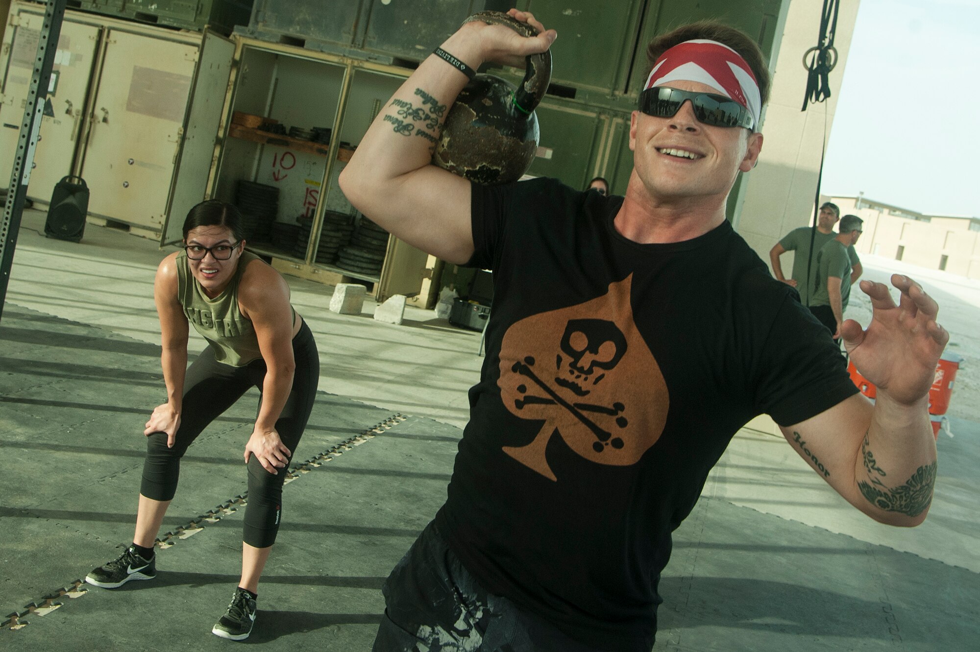 U.S. Air Force Staff Sgt. Cory Lesinger, right, 329th Expeditionary Civil Engineer Squadron, and Senior Airman Erica Garcia, 379th Expeditionary Logistics Readiness Squadron, compete in the 2018 EOD 133 Memorial Workout Nov. 4, 2018, at Al Udeid Air Base, Qatar. The event was held in honor of U.S. Army Sgt. James Slape, 430th Explosive Ordnance Company, who was killed by an improvised explosive device Oct. 4, 2018. (U.S. Air Force photo by Tech. Sgt. Christopher Hubenthal)