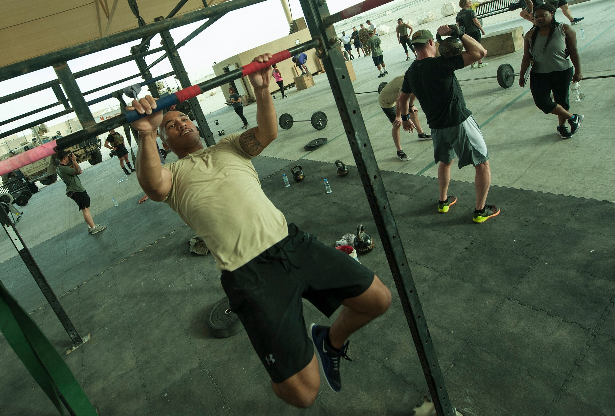 U.S. Air Force Staff Sgt. Johnathan Flynn, 379th Expeditionary Security Forces Squadron, performs pull-ups during the 2018 EOD 133 Memorial Workout Nov. 4, 2018, at Al Udeid Air Base, Qatar. The event was held in honor of U.S. Army Sgt. James Slape, 430th Explosive Ordnance Company, who was killed by an improvised explosive device Oct. 4, 2018. (U.S. Air Force photo by Tech. Sgt. Christopher Hubenthal)